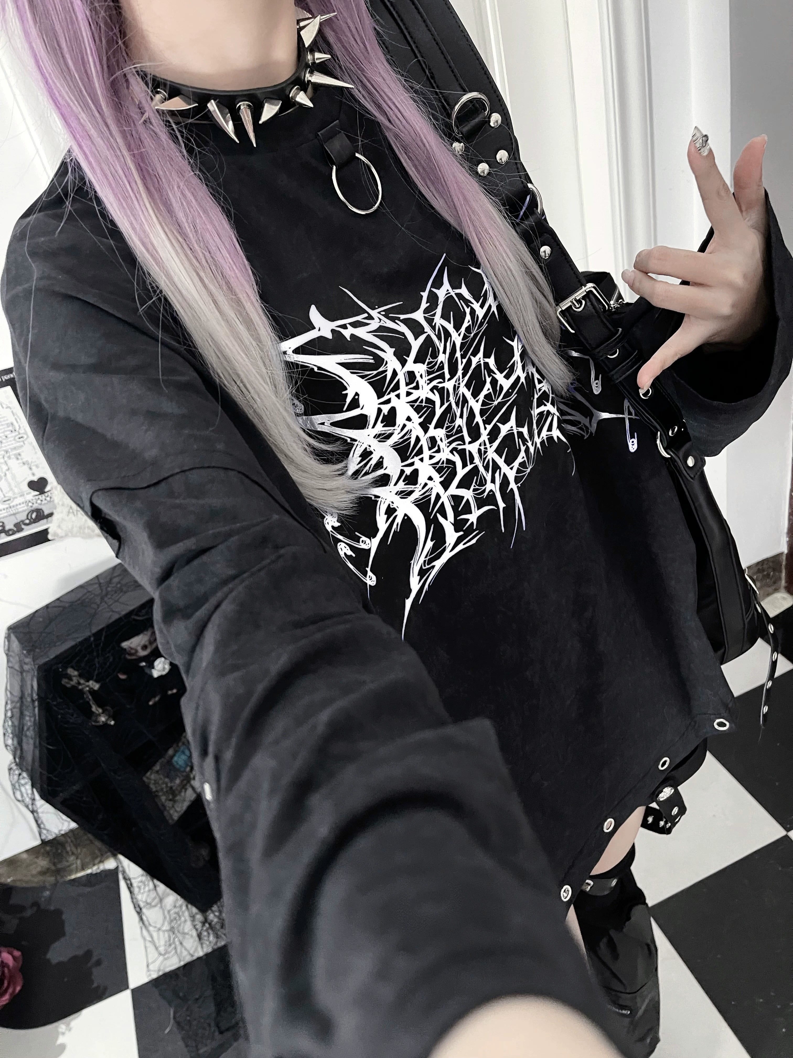 Color variation showcase of jirai kei gothic long-sleeve tee in multiple colorways including black-and-white, black-and-purple tie-dye options with thorn cross print