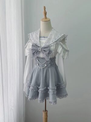 Flat lay display of complete ryousangata two-piece jirai kei outfit featuring lace sailor collar blouse with detachable bow and high-waist skirt with pearl chain waist decoration