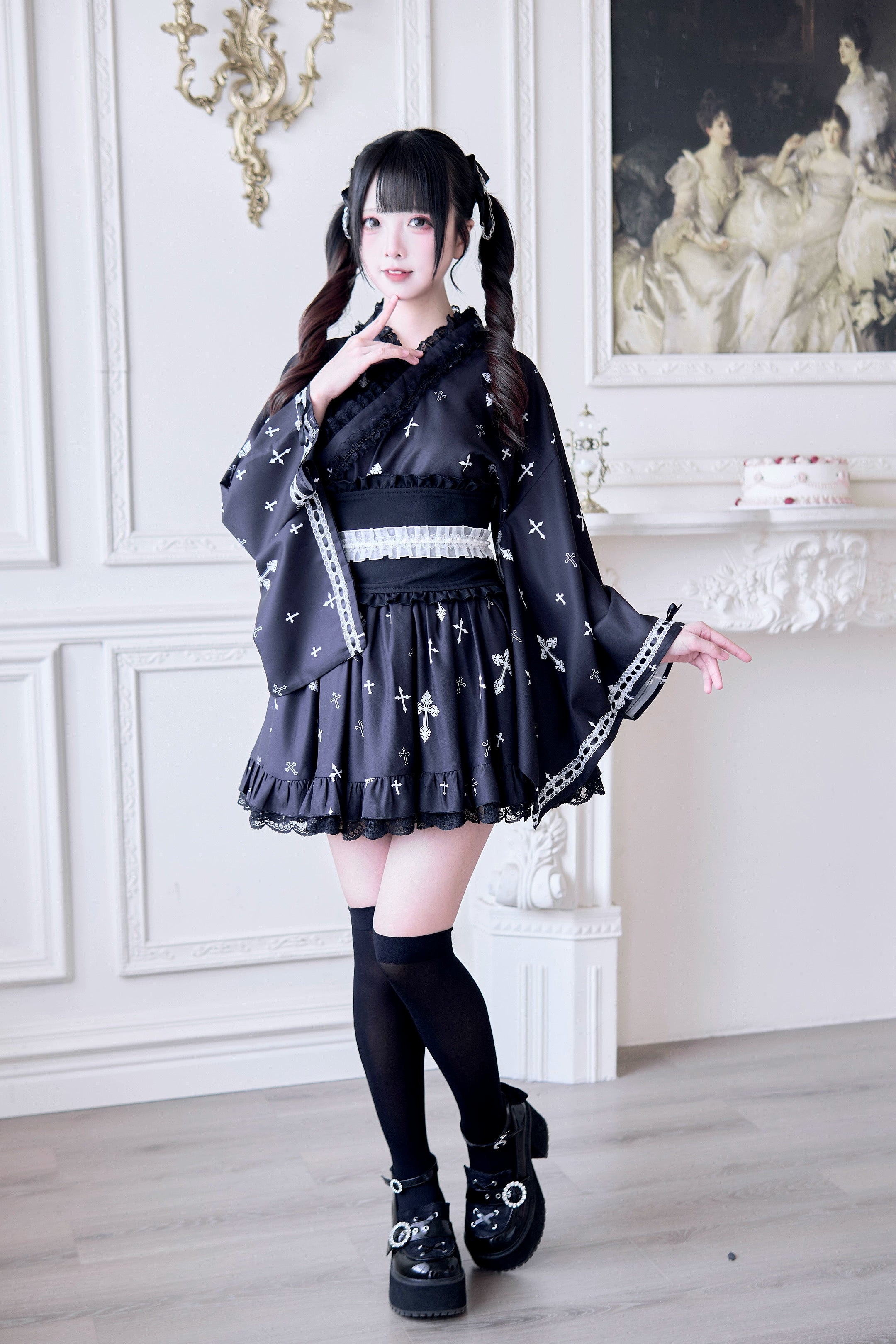 Black Jirai Kei kimono outfit with white lace trim accents and cross print pattern - front view showing twin-tailed model wearing platform boots and wide waist belt