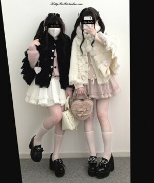 Side view of white and light pink double-layered tulle mini skirts with ruffled hem details worn by two girls in black cream Jirai Kei outfits with platform loafers and matching handbags