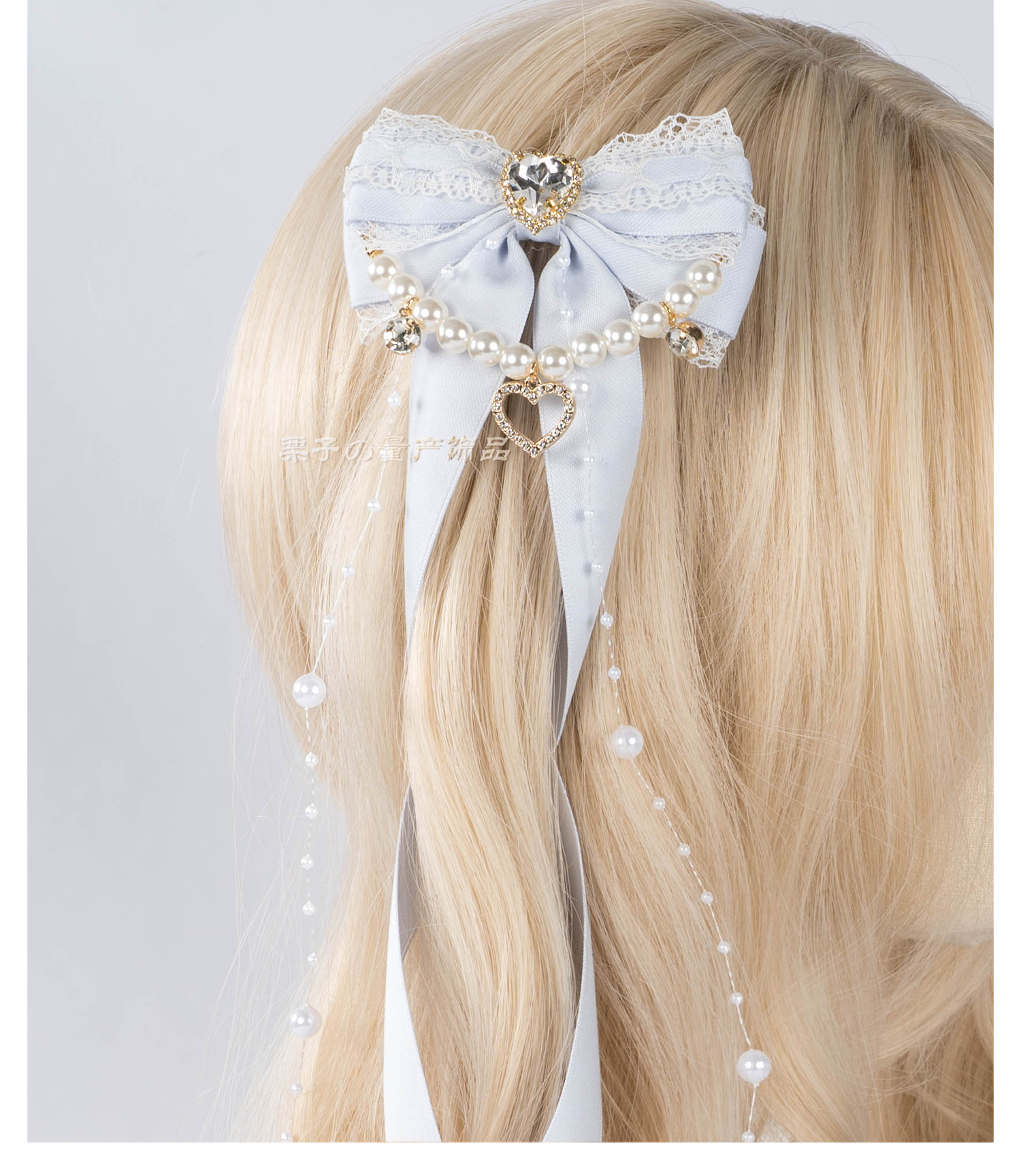 Jirai Kei bow hair clips with pearl chain hanging down showing length and ornamental chain drape detail