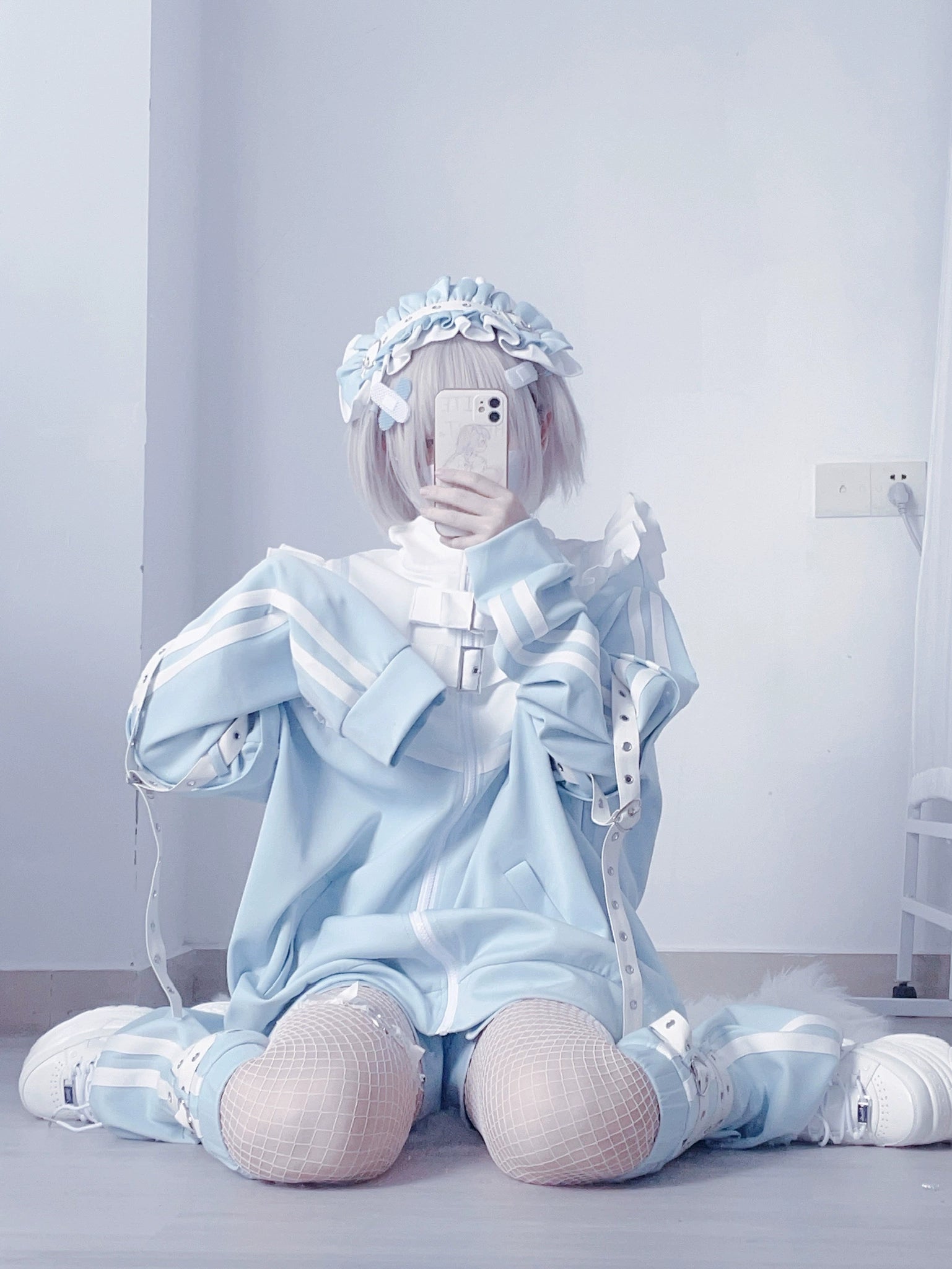 Oversized Tenshi jacket with ruffled shoulders long sleeves seated front view model with frilly hairband blue white color scheme