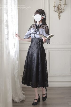 Black maxi Jirai Kei skirt with purple cape blouse ensemble, three-quarter front view showcasing sheer ruffle cape top and black plaid mesh midi skirt in vintage French interior setting