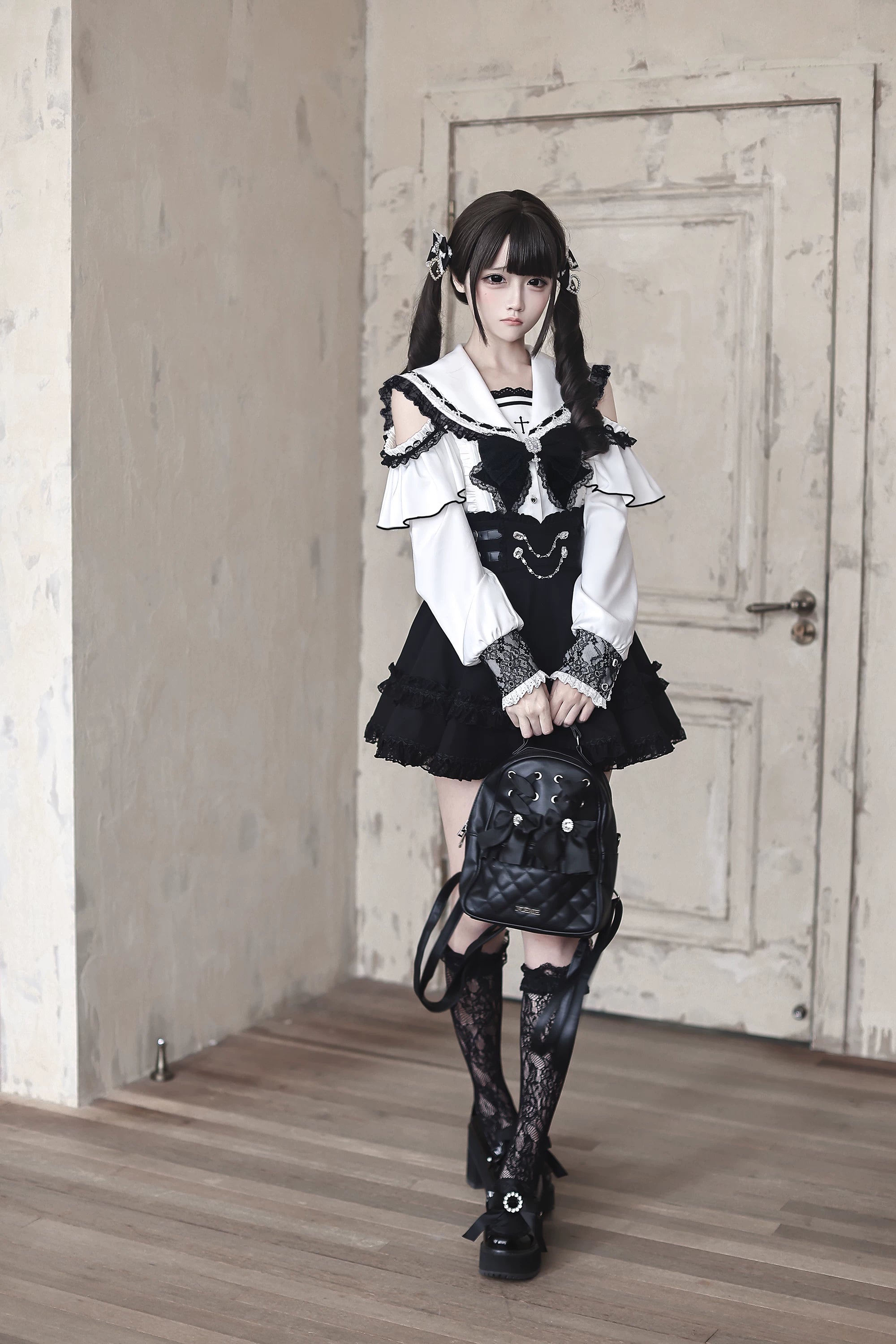 Complete Jirai Kei sailor collar two-piece ensemble including blouse with decorative bow and skirt with chain waist accent detail shot