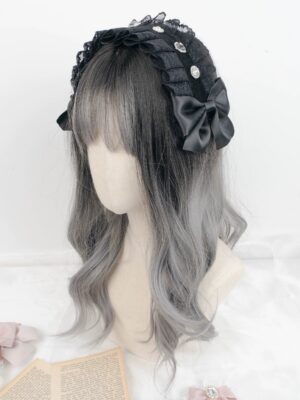 Black pleated lace Jirai Kei hair headdress featuring round rhinestones and large satin bow, side front angle on ombre wig mannequin