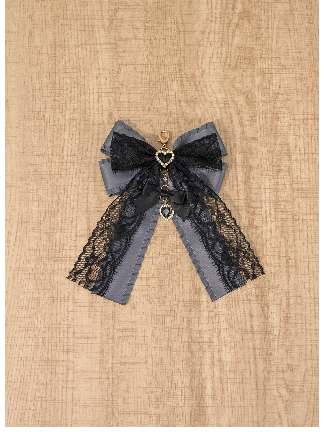 Dark grey and black layered Jirai Kei lace bow brooch with hanging rhinestone heart charm, reversible brooch pendant styling