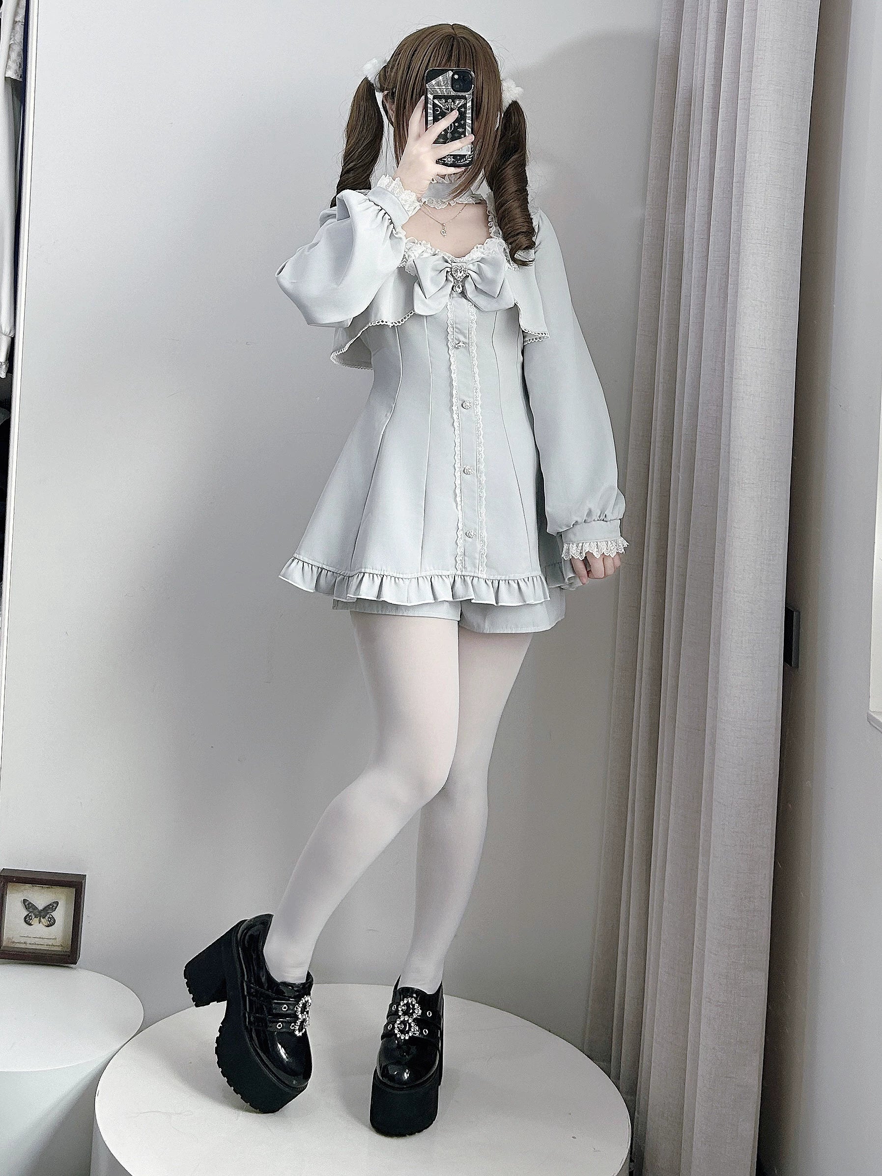 Jirai Kei long-sleeve dress with removable chest bow and pocketed shorts in black and gray colorways, product styling detail shot