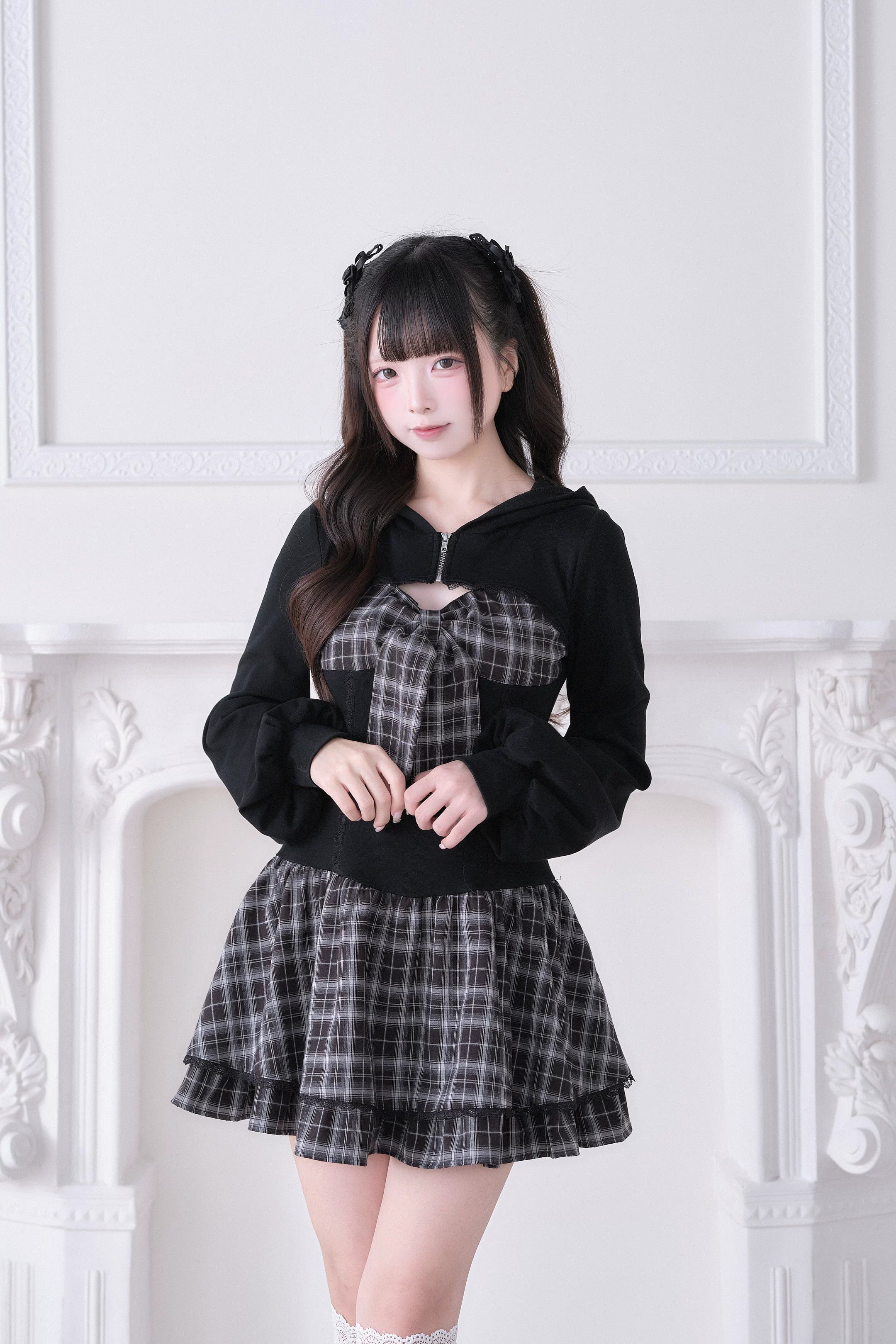 Black plaid Jirai Kei hoodie dress front close-up detail showing half-zip collar, plaid bow accent and ruffled mini skirt