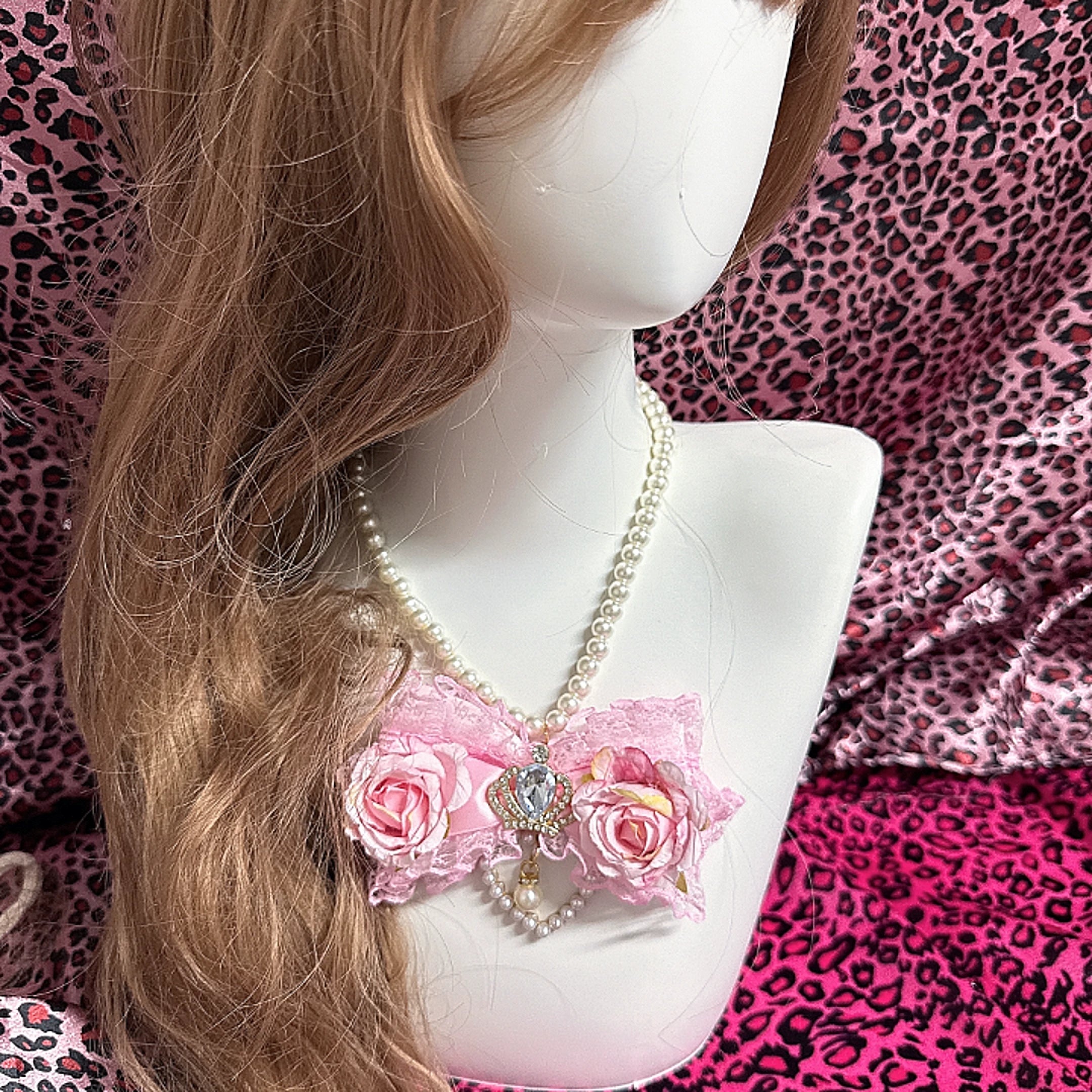 Jirai Kei floral bow pearl necklace worn on mannequin three quarter front view showcasing pink rose lace design