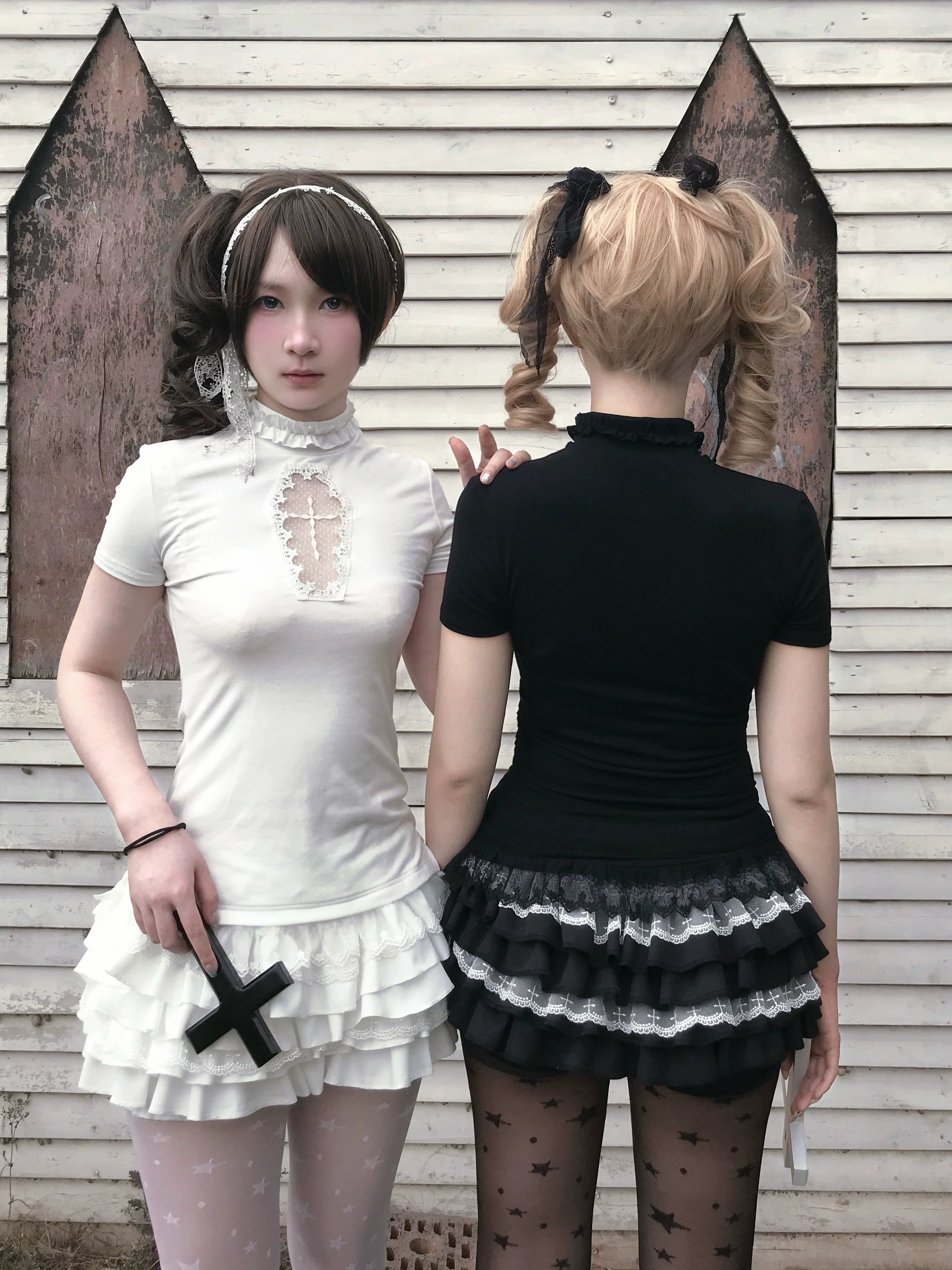Black gothic outfit with cross motif details hand pose showing embellishment and construct quality