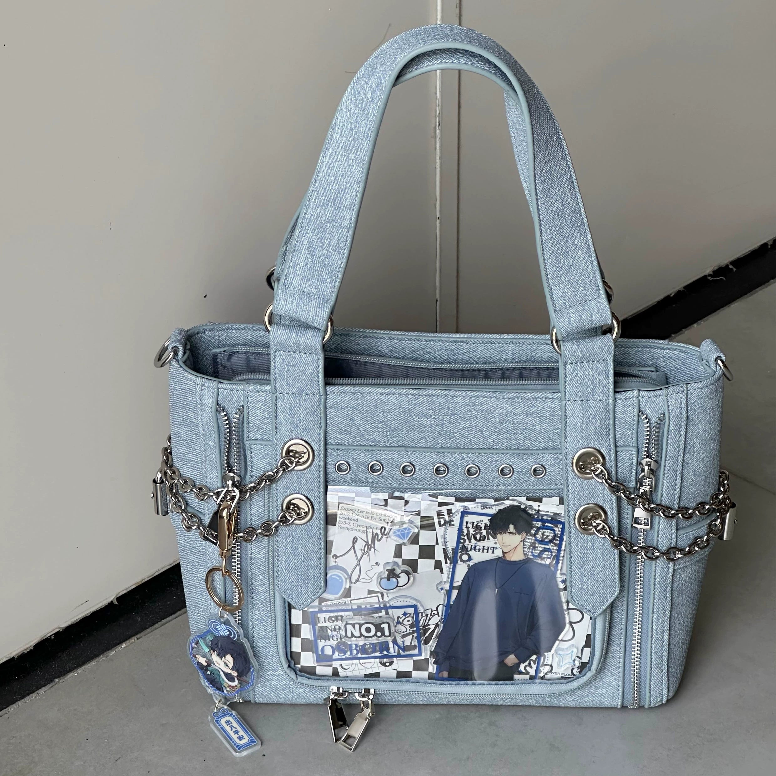 Light blue denim Jirai Kei ita tote bag close-up showing metal chains rivet trims and custom anime display inserts