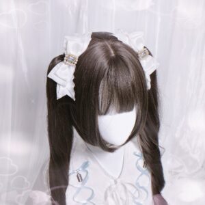 White vintage bow hair clips set with square rhinestone and pearl accents shown on twin-tail wig mannequin featuring ruffled satin edges and jirai kei styling