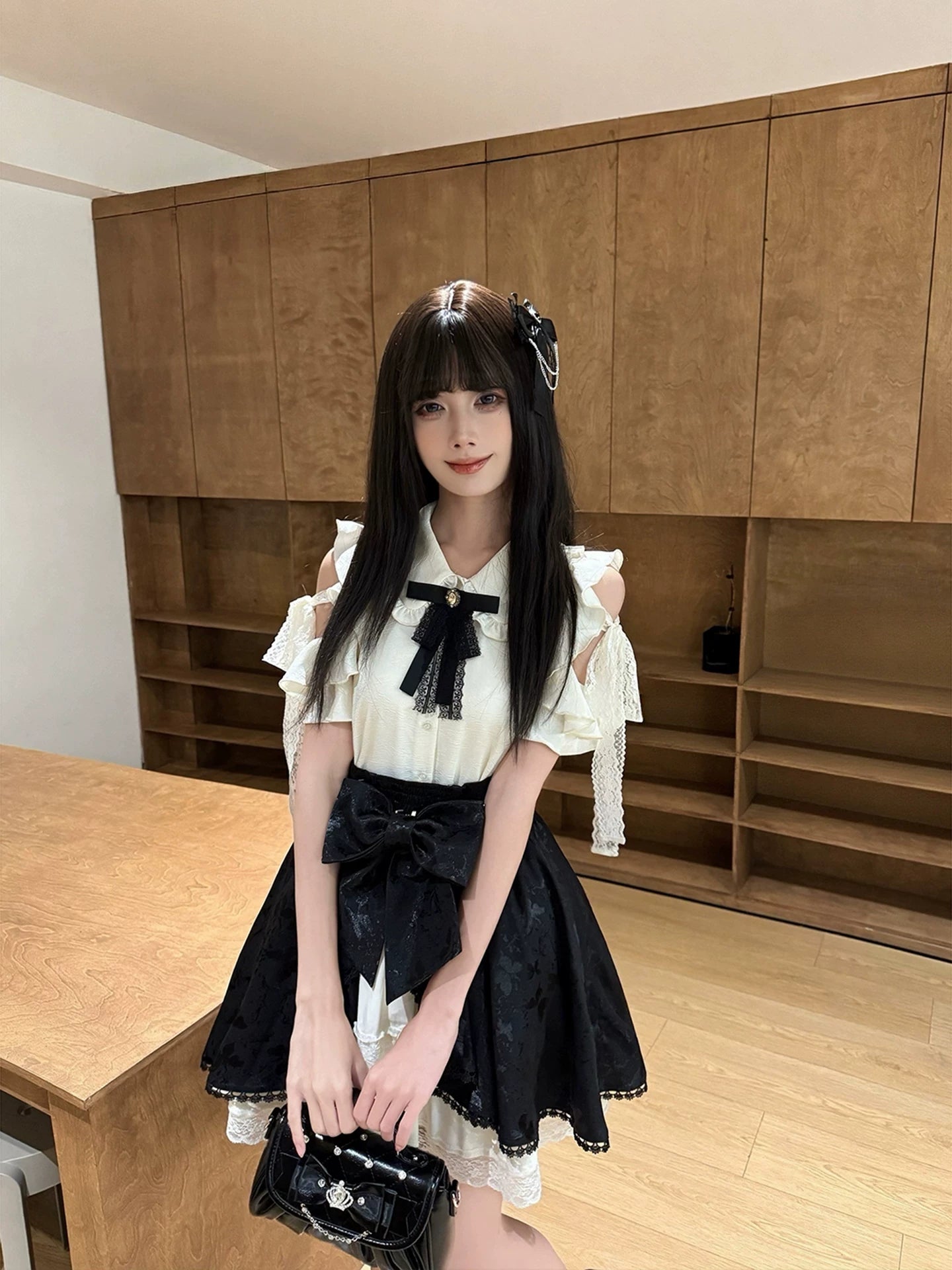Seiso Kei two-piece set front standing view with model holding black handbag showcasing complete ensemble styling