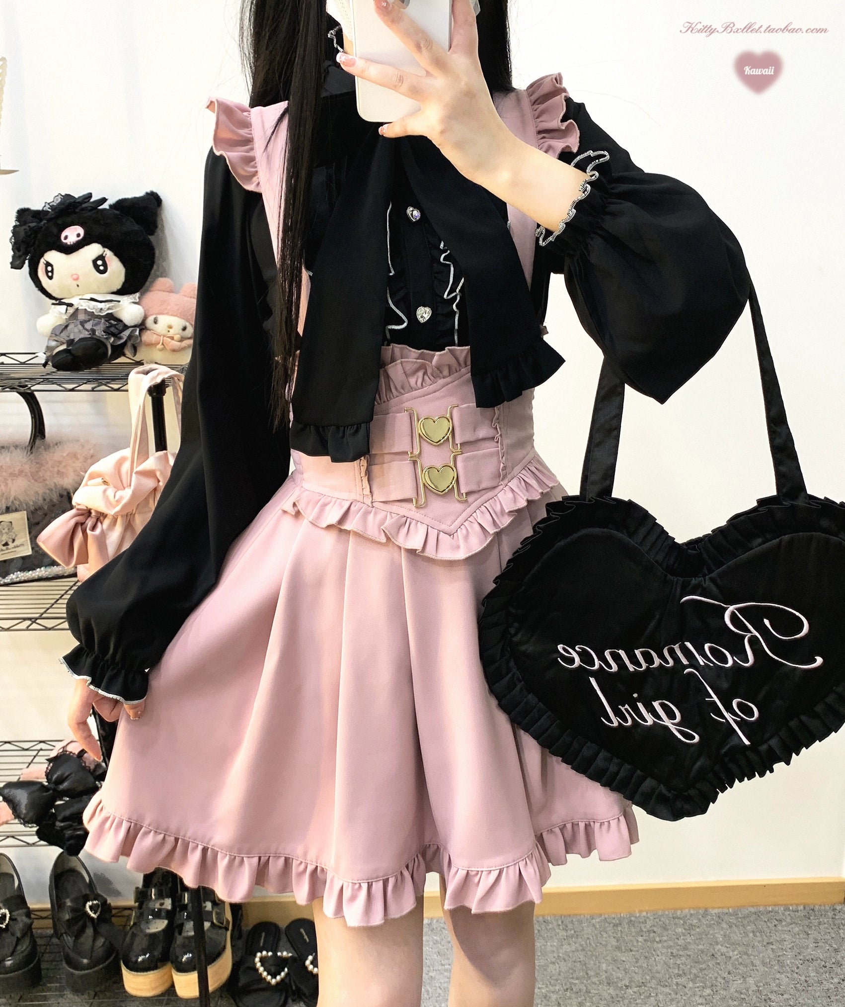 Pink ruffled pleated Jirai Kei suspender skirt close-up detail shot showing double heart-shaped metal buckle waistband and ruffled hem texture