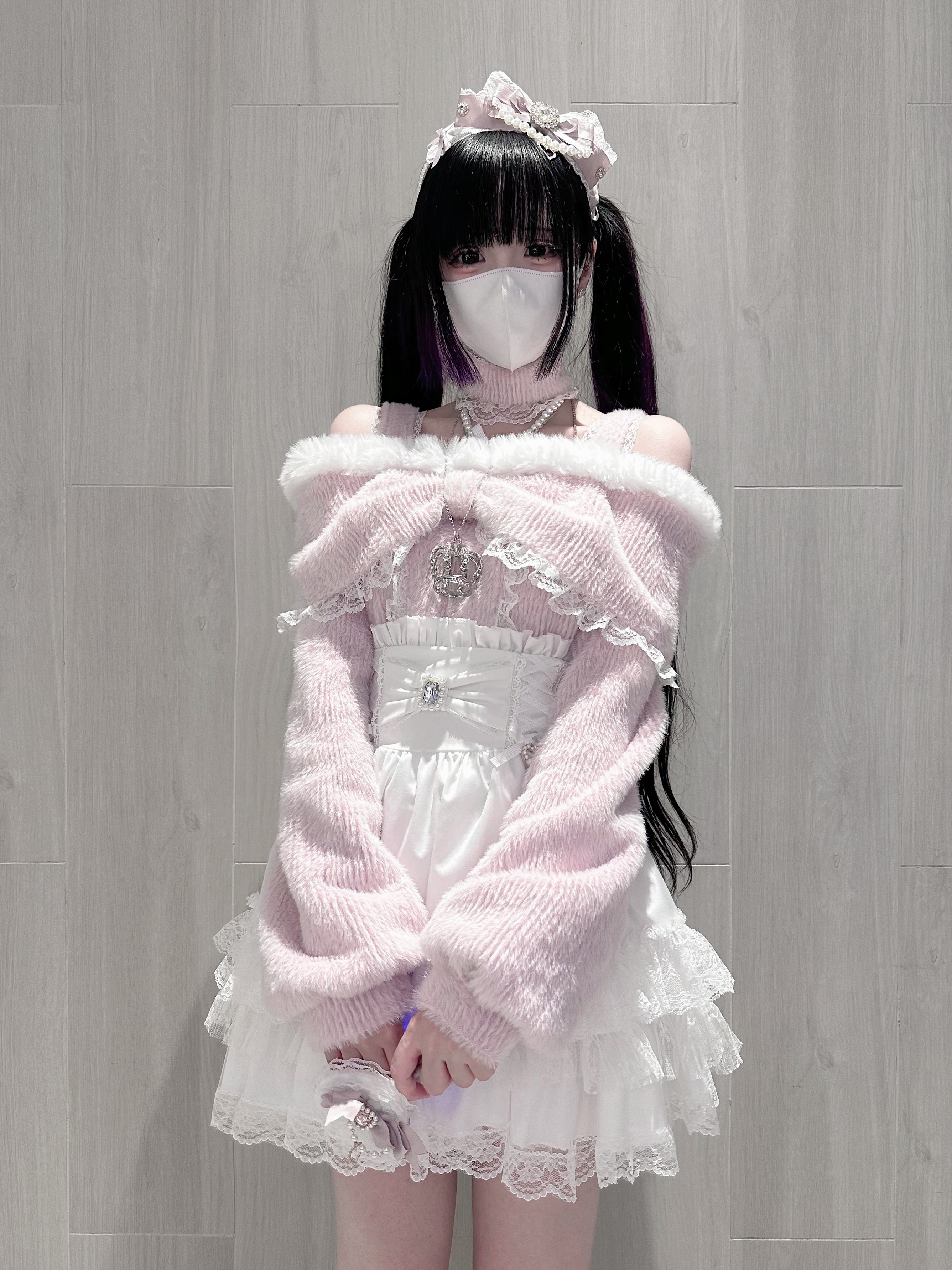 Pink off-shoulder plush knit top with ruffle collar and attached pearl choker worn by twin-tailed goth girl, indoor studio photography