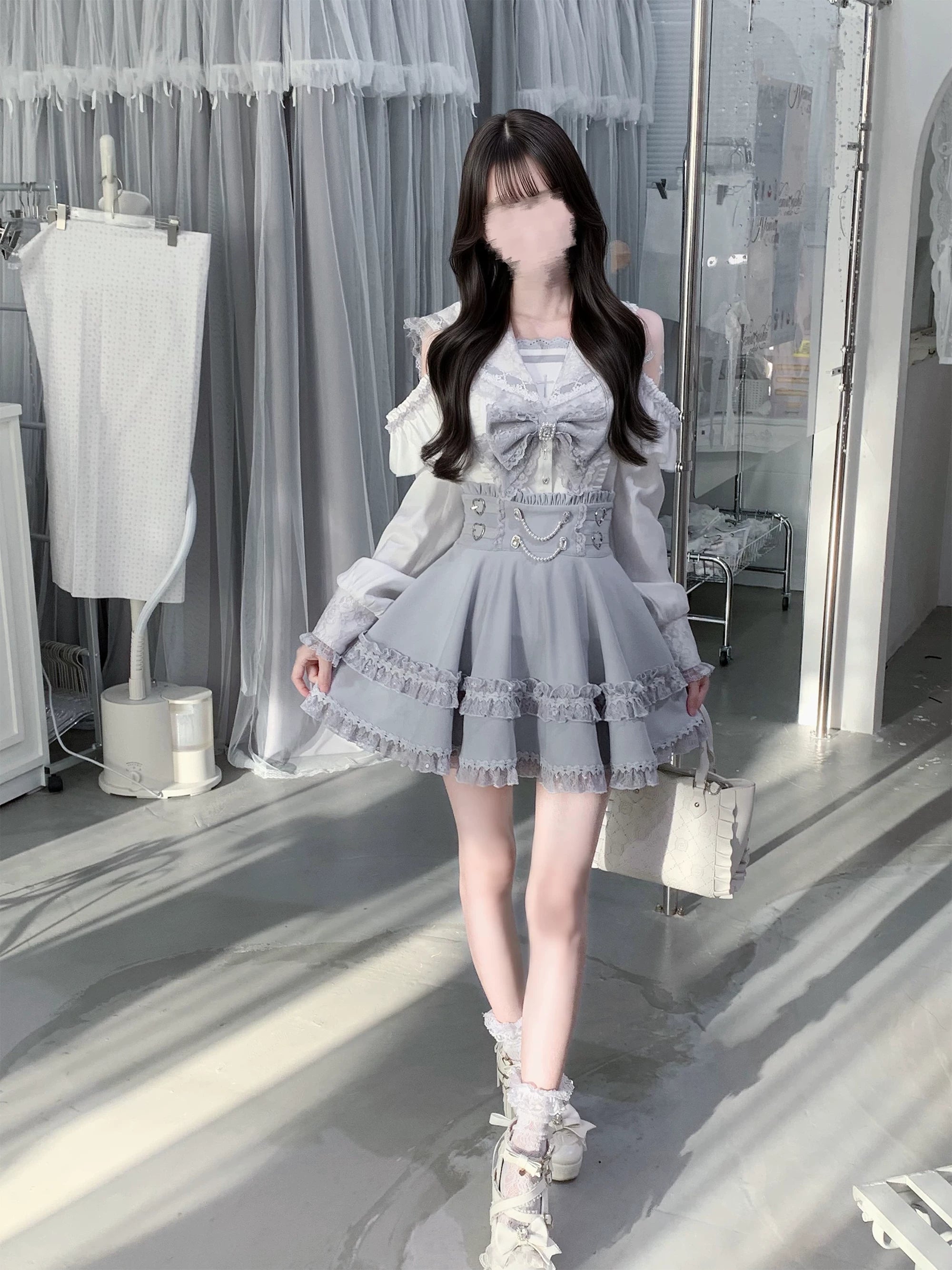 Full body front pose of ryousangata jirai kei two-piece ensemble showing cold-shoulder blouse with cross-stitch chest embroidery waist chain decoration and layered ruffle skirt