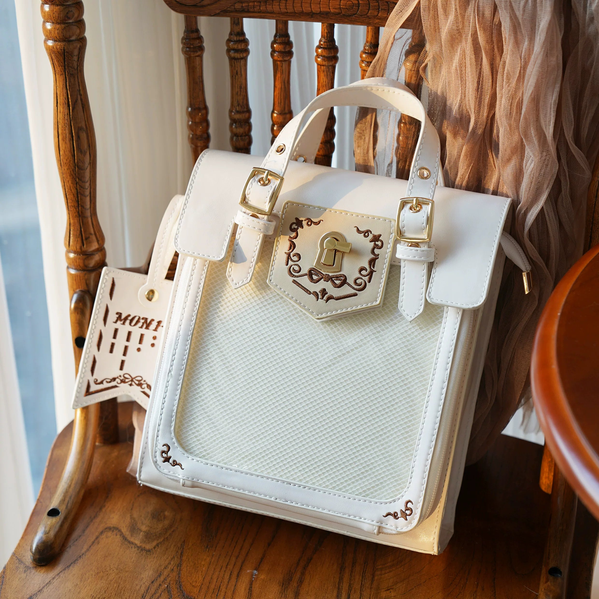 White vintage embroidered Jirai Kei ita bag with full clear acrylic display window and color coordinated mini badge charm accessory, pristine canvas color option