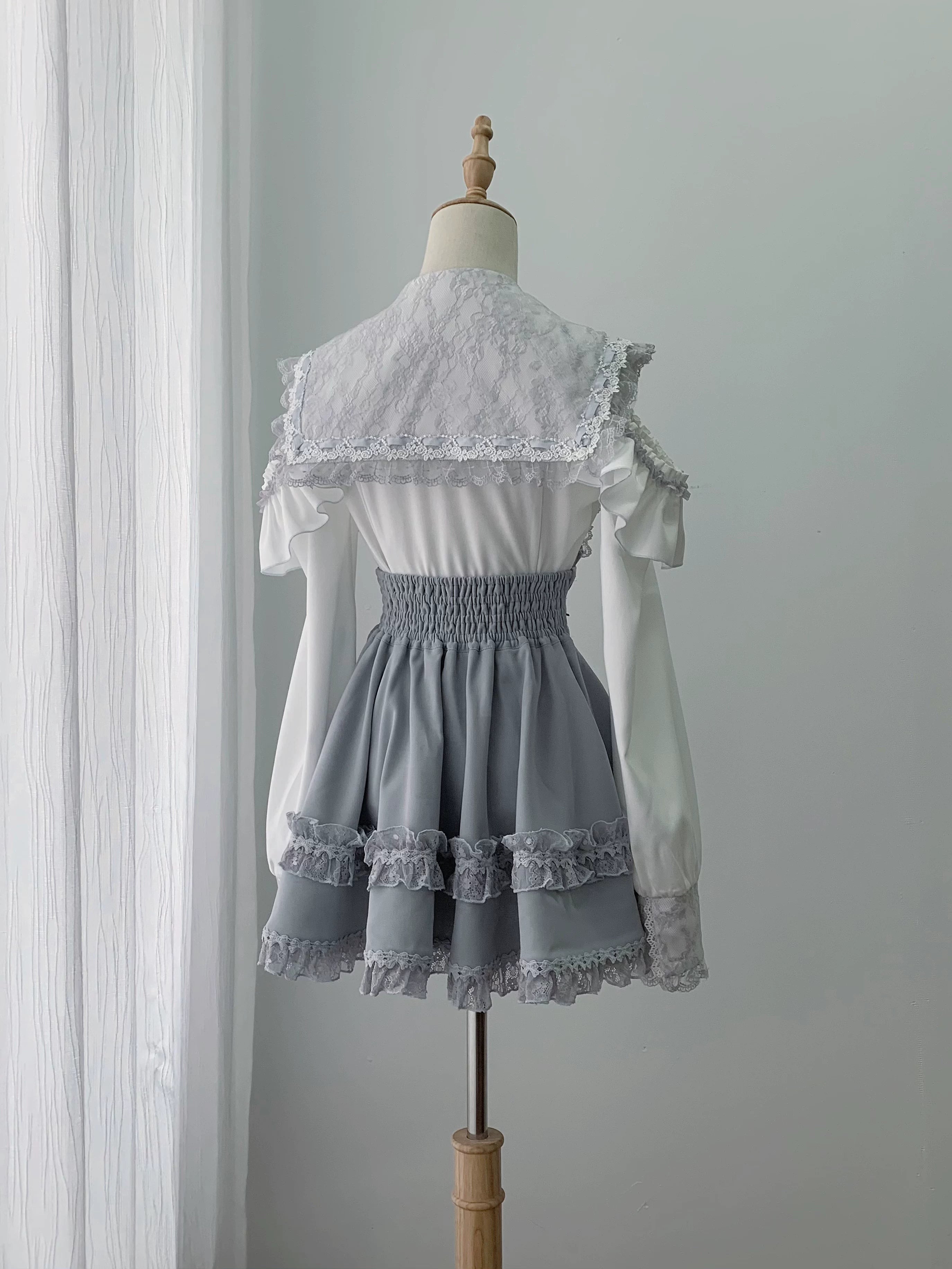 Back view of ryousangata sailor collar blouse and skirt showing elastic high waist design lace back collar overlay and multi-layer ruffled lace hem detail