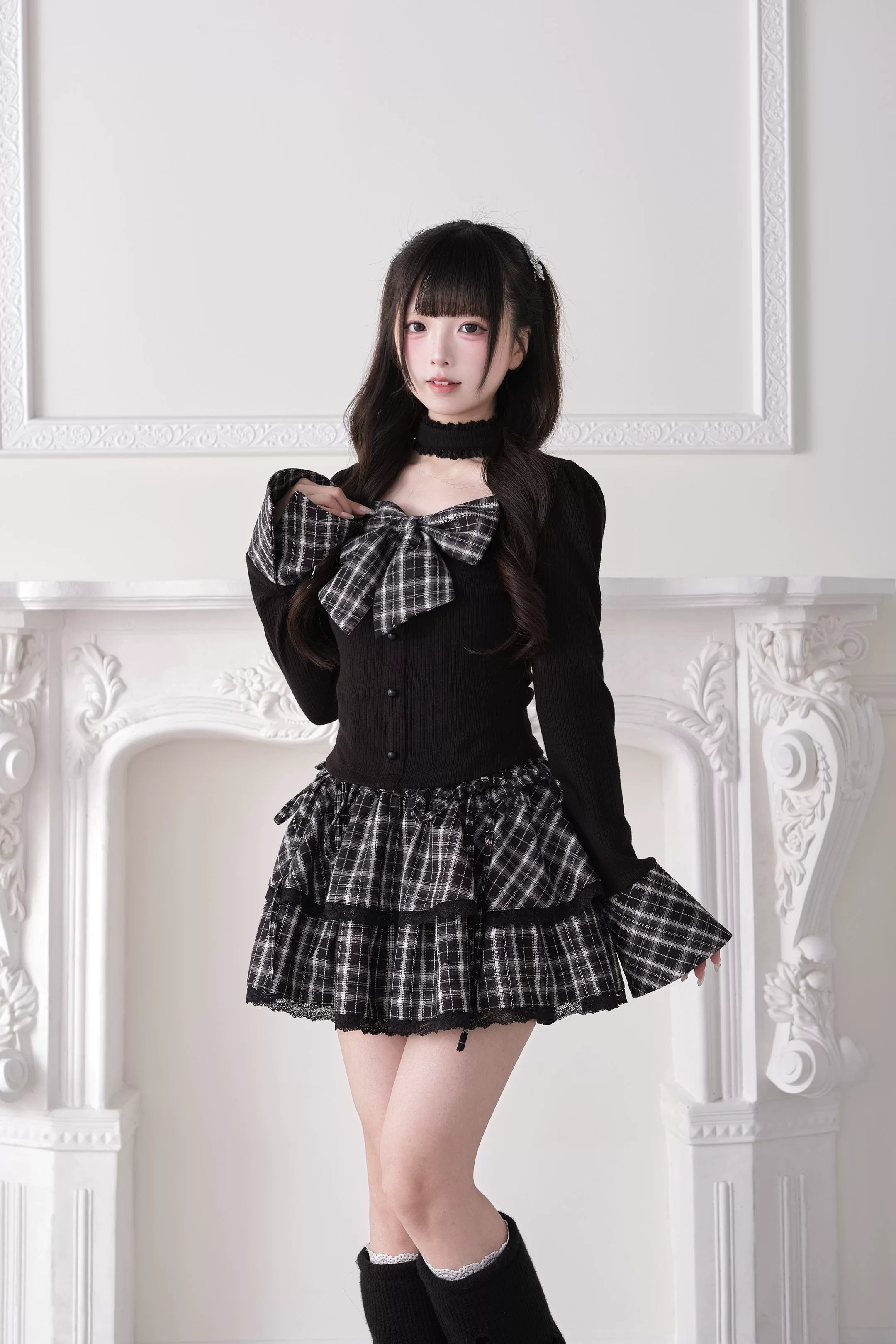 Black Jirai Kei choker knit top with flared cuffs plaid bow and black boots three-quarter view