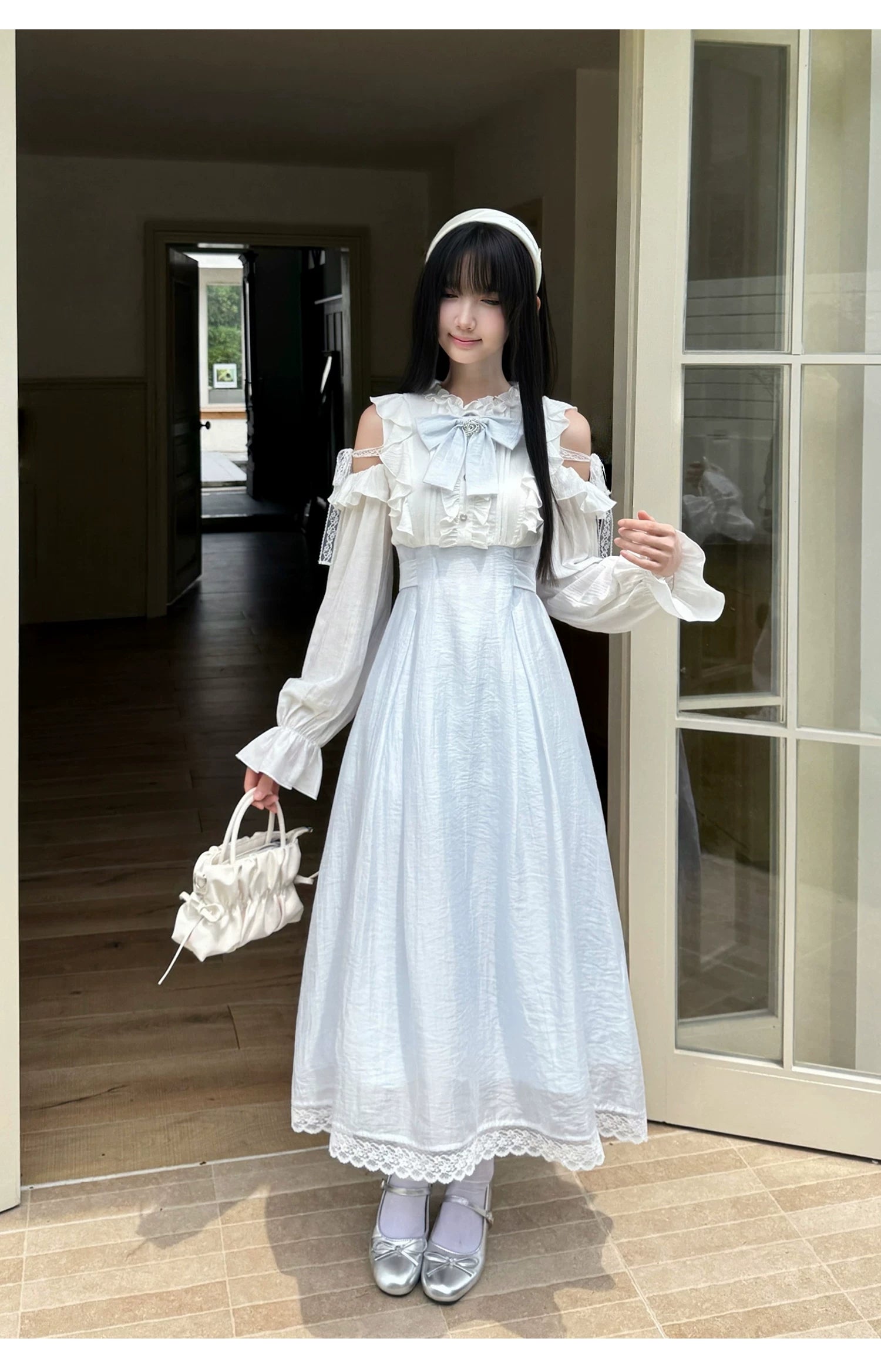 Seiso Kei short dress with short sleeves showing ruffled details and waist bow styling in indoor setting