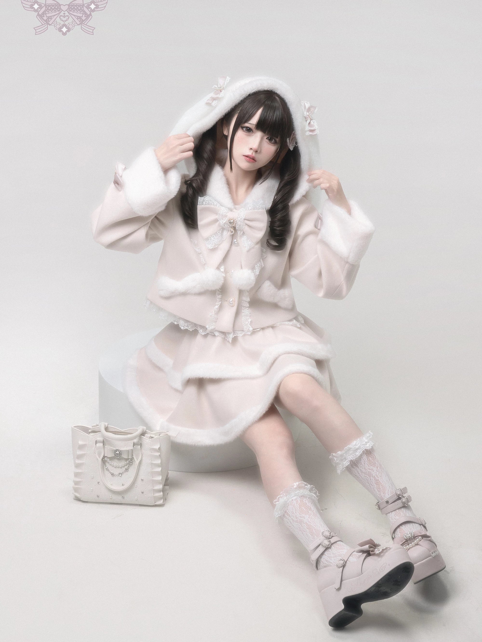 Ryousangata lolita coat with bunny ears and large removable bow collar sitting pose front view, tiered ruffle skirt with fur trim details, Jirai Kei winter aesthetic