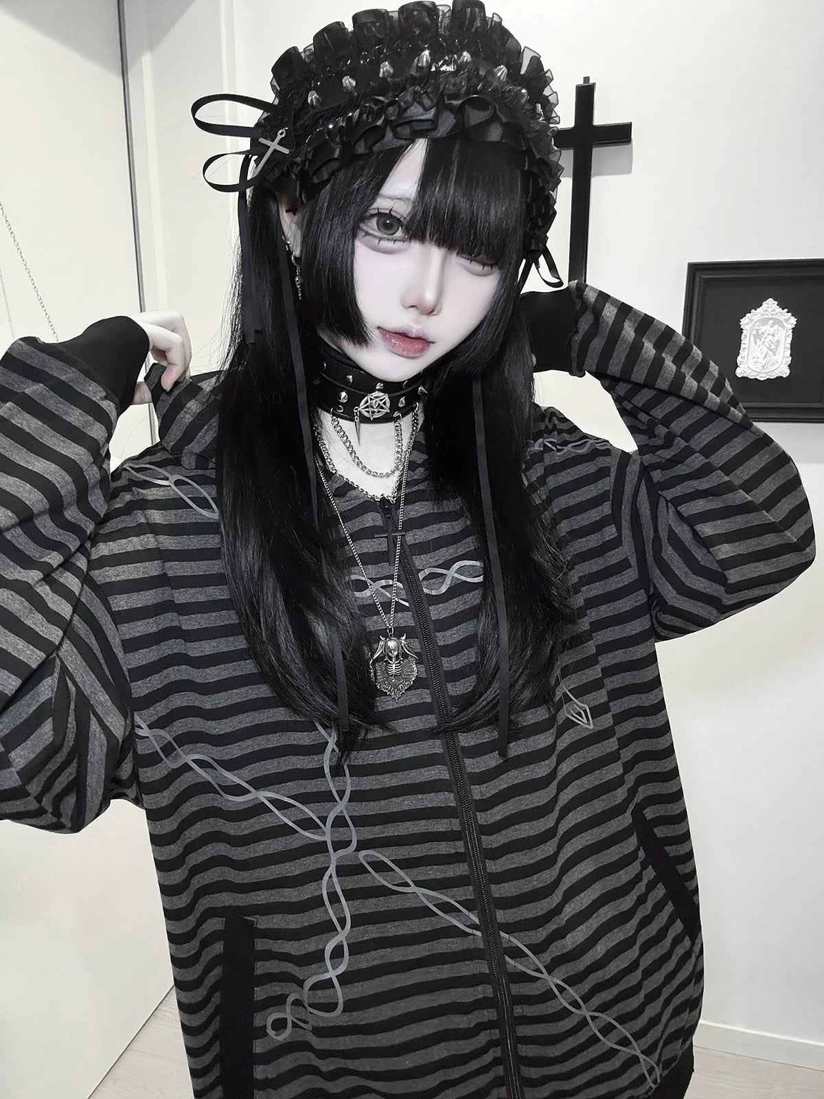 Dark aesthetic striped hoodie paired with wide-leg black trousers and platform boots creating alternative fashion complete look
