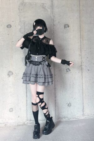 Black off-shoulder lace ryousangata blouse paired with plaid skirt, industrial urban setting, full body jirai kei fashion shoot