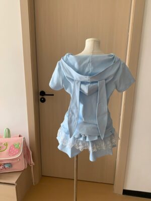 Back view of blue Jirai Kei kawaii outfit set showing oversized bunny ear hood details and layered ruffled lace skirt hem