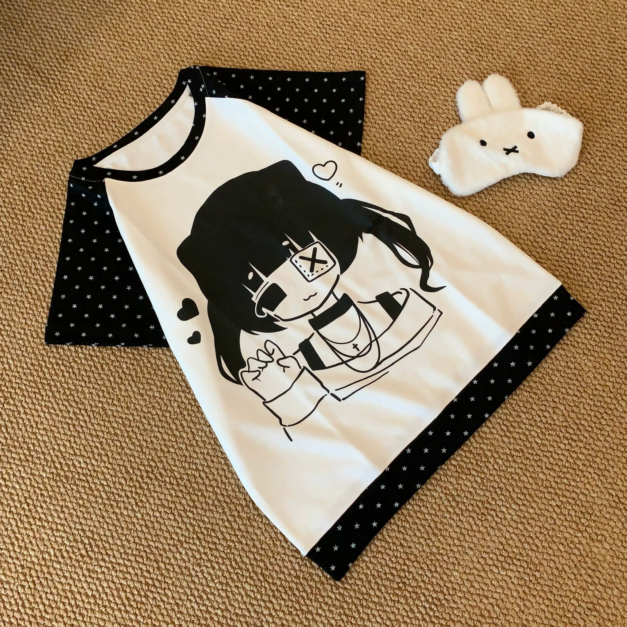 Jirai Kei kawaii raglan tee with cute cartoon girl graphic and polka-dot trims oblique flat lay view aesthetic styling