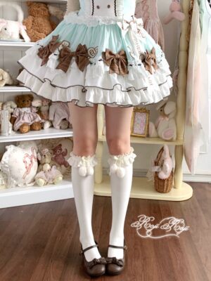 Ivory Jirai Kei over-the-knee combed cotton socks with brown ruffled bow cuffs, paired with brown Mary Jane shoes and mint-brown Sweet Lolita dress, indoor aesthetic shoot with plush toy display