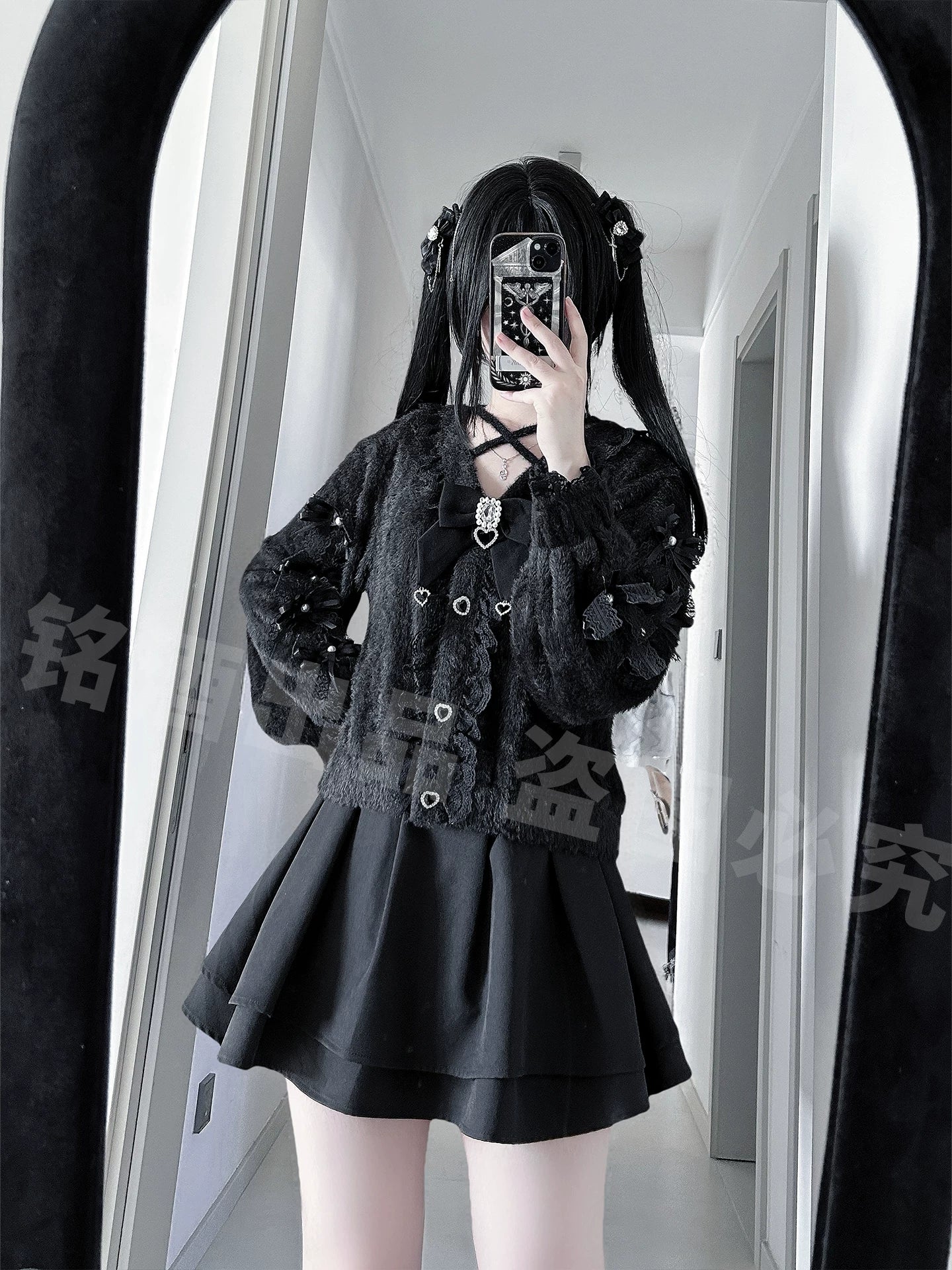 Twin ponytail model wearing black Jirai Kei cardigan and pleated mini skirt mirror selfie lace sleeve trim details
