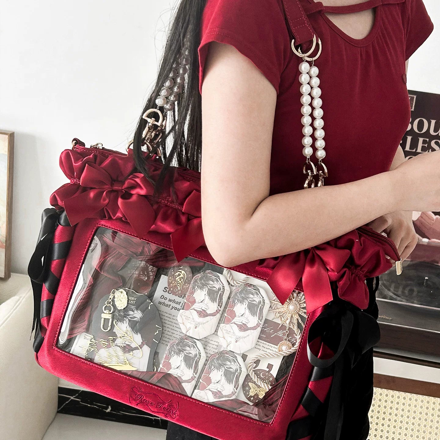 Wine red Jirai Kei laptop itabag back side view with large red ruffled bows pearl chain strap and clear photo display window showing character collectibles