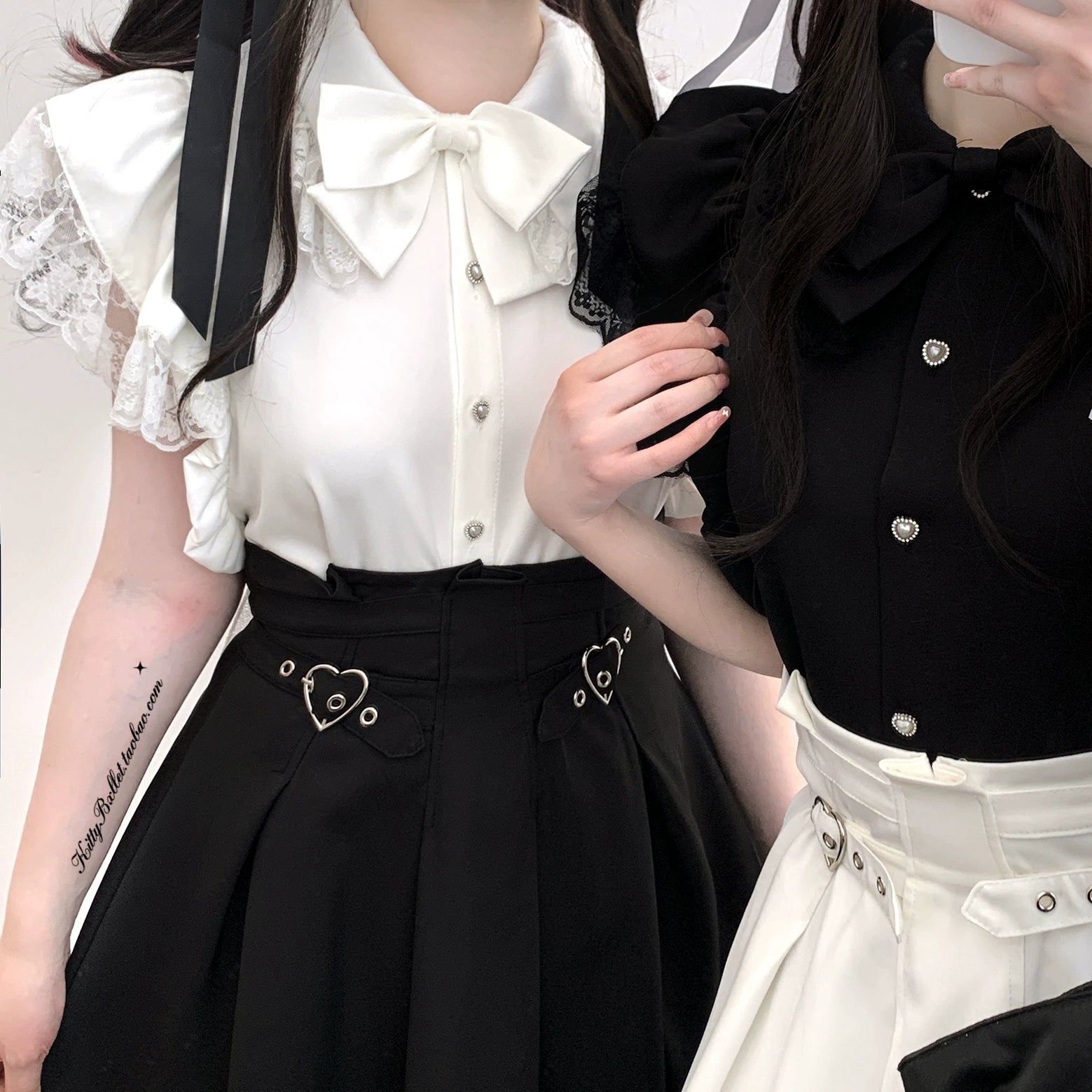 Detailed half-body shot of Jirai Kei outfit showing white blouse with big bow tie and pearl buttons paired with black skirt featuring heart buckles