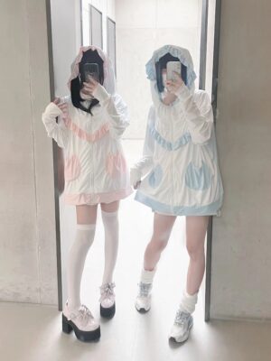 Full-length mirror selfie of Tenshi Kaiwai cat-ear hooded UPF50 sun protection jacket with ruffled chest trim and cat pocket patterns in casual home setting