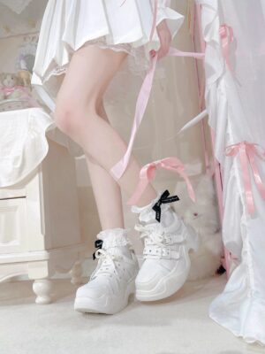 White Y2K platform sneakers detail shot featuring buckle strap mechanism, rounded toe cap, and smooth leather texture close-up