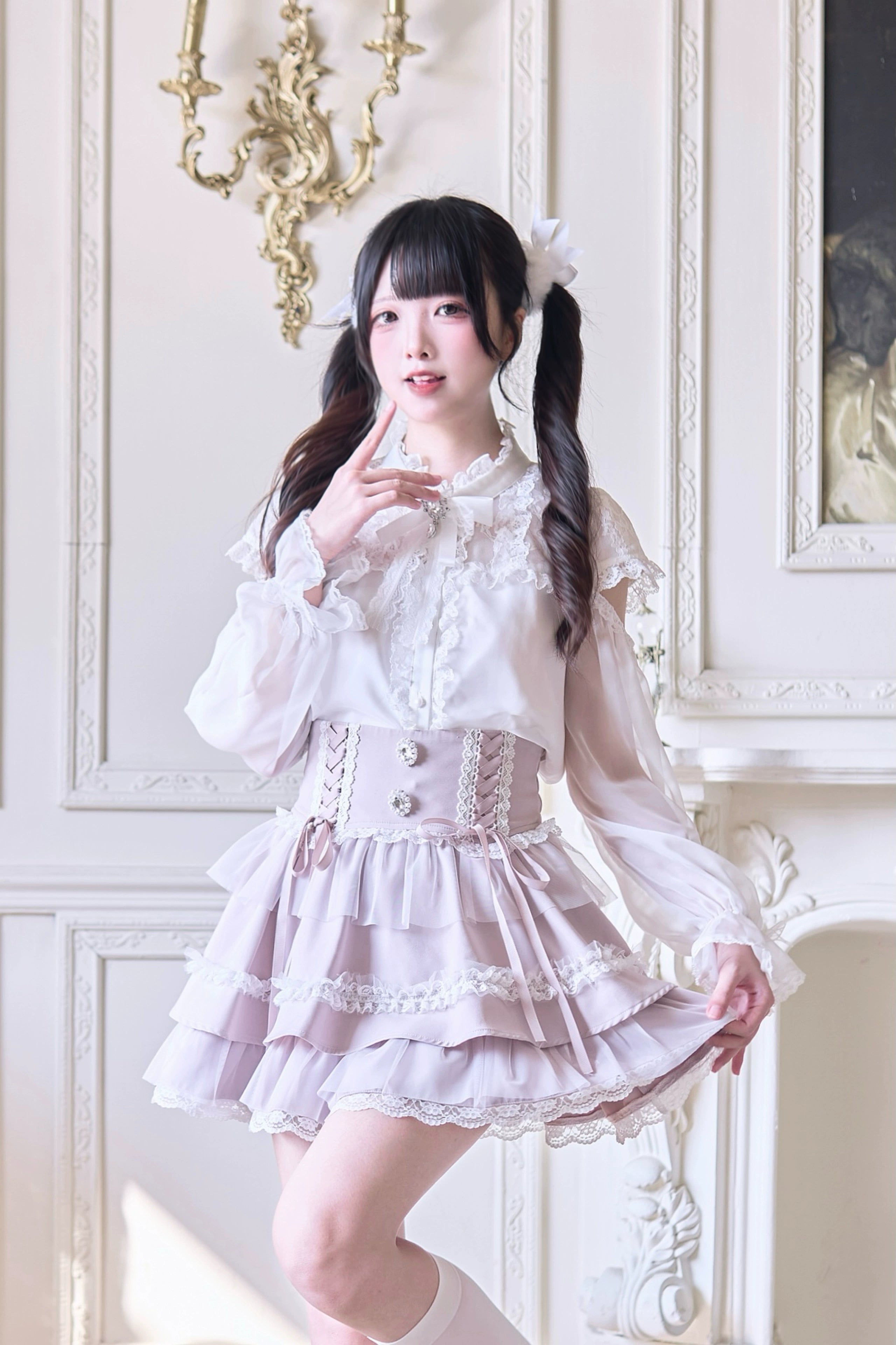 Three-quarter front angle of flared tiered Jirai Kei skirt with lace embellishments and mesh hem detail