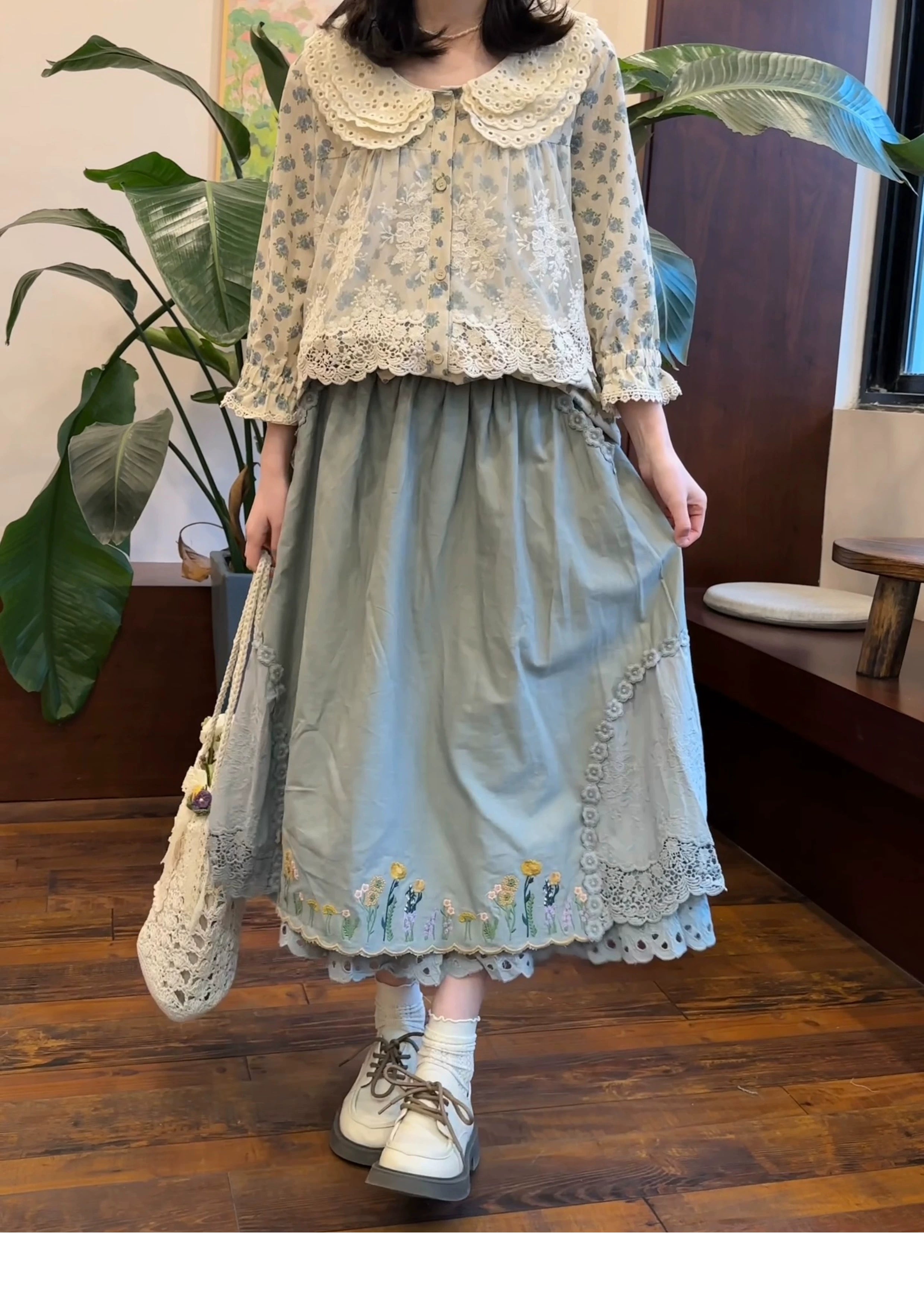 Mori style two-piece outfit dusty blue embroidered skirt cropped floral blouse peter pan collar woven flower tote front half view