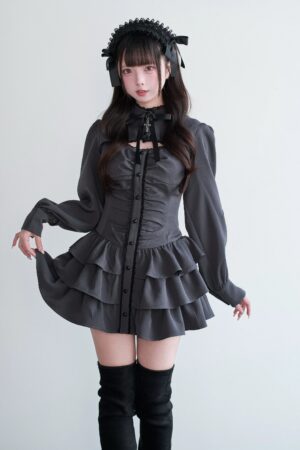 Black gothic Jirai Kei dress front standing view with ruched bodice button closures and flared ruffled skirt hem