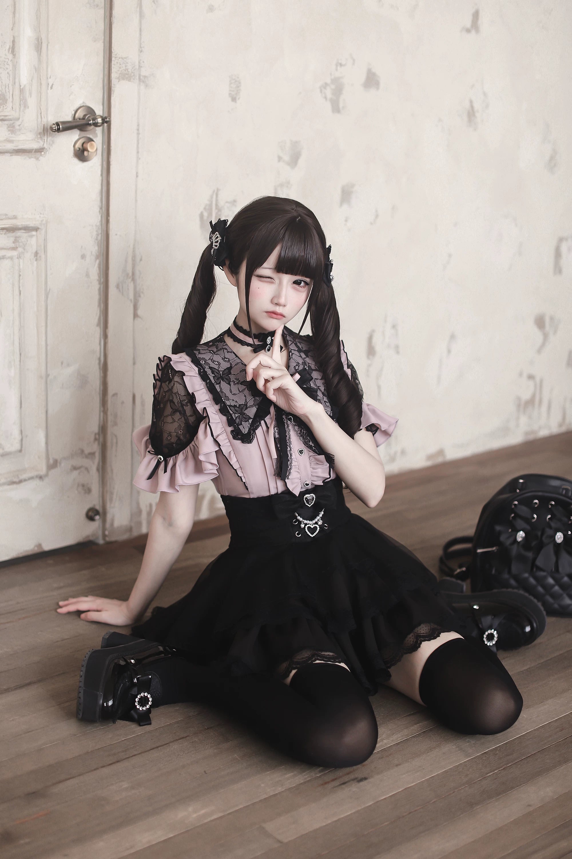 Red and black Jirai Kei blouse with blue bow tie and choker accessories complete look