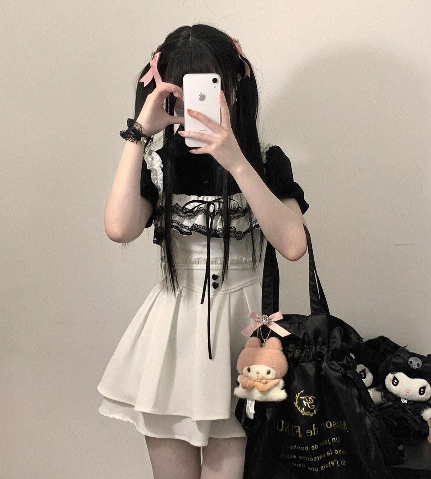 White Jirai Kei chiffon blouse with delicate lace bust trim and heart-shaped buttons, paired with suspender mini skirt, full front mirror selfie with pink hair accessories