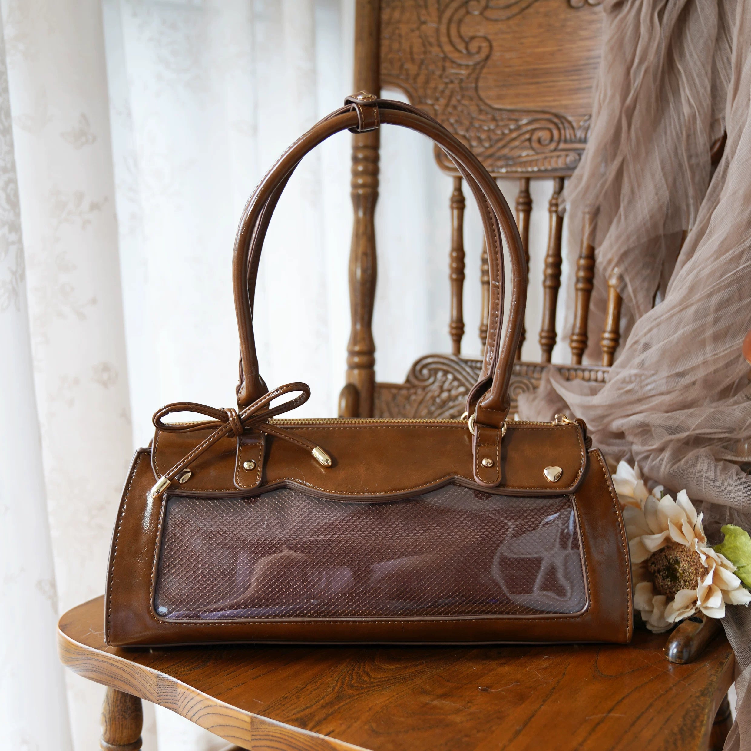 Brown baguette itabag with anime collectible showcase display and removable crossbody shoulder carrying strap