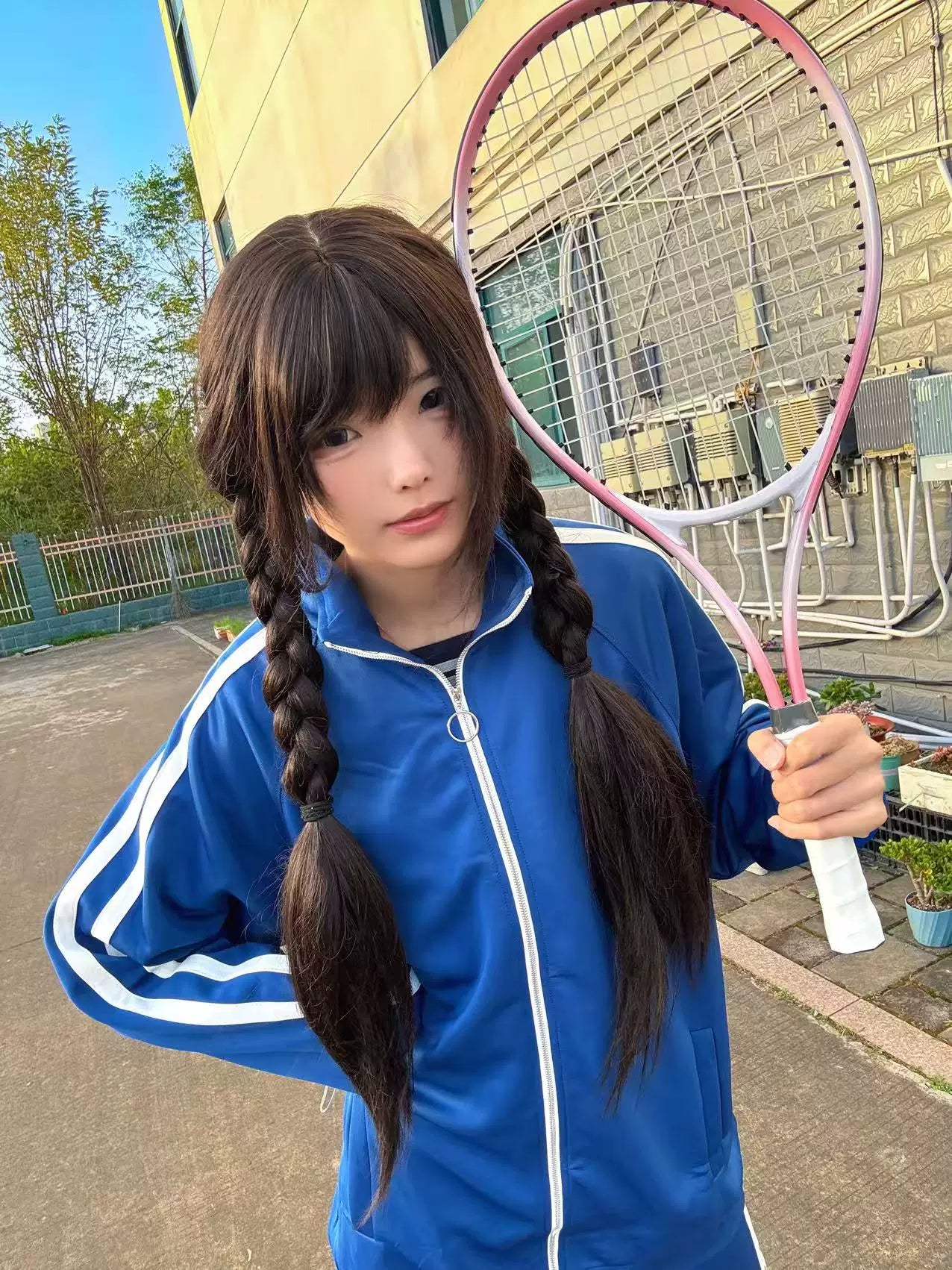 Royal blue track jacket with full front zipper white sleeve stripes side front angle model with pink racket