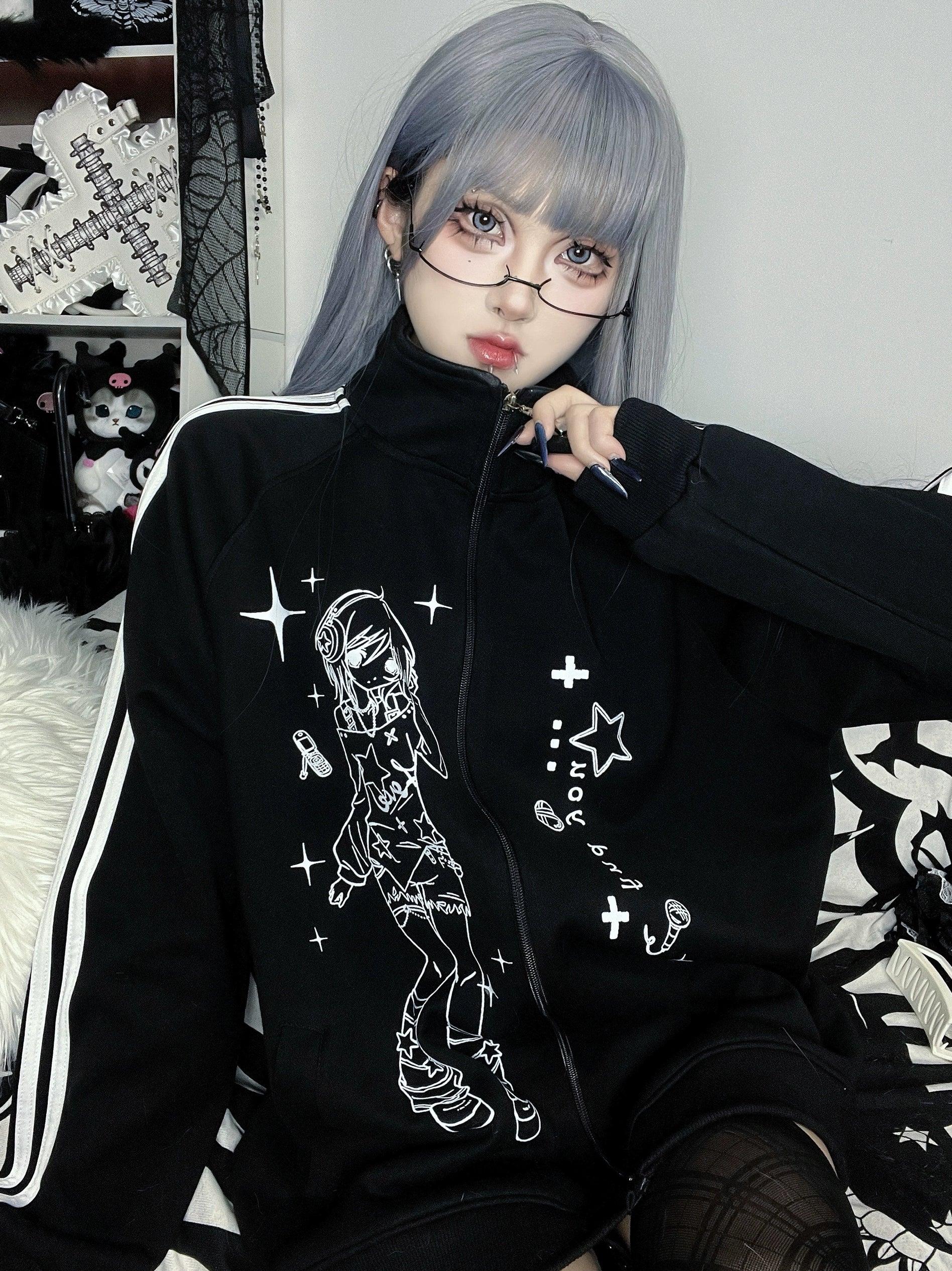 close-up detail of black stand collar zip jacket showing anime character print quality, ribbed cuffs and hem finishing