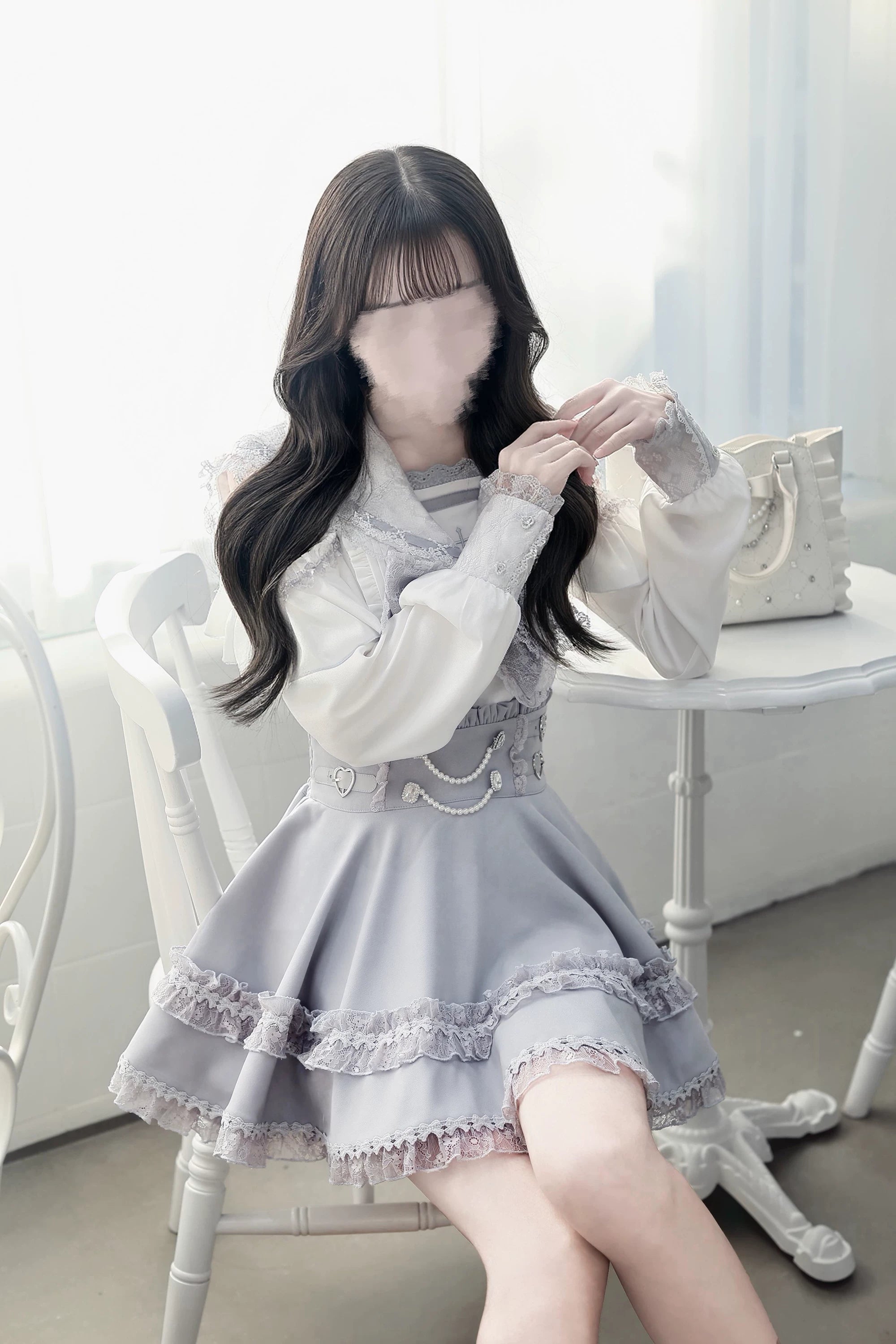 Detail view of ryousangata jirai kei skirt featuring multi-layer ruffled lace hem high-waist construction with pearl chain and heart shaped waist embellishments