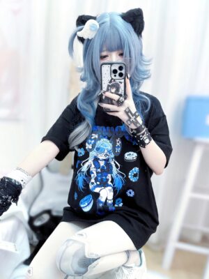 Side seated mirror selfie of oversized anime punk T-shirt showing black fabric with blue anime girl graphic design, paired with punk wrist accessories and band-aid themed decorations