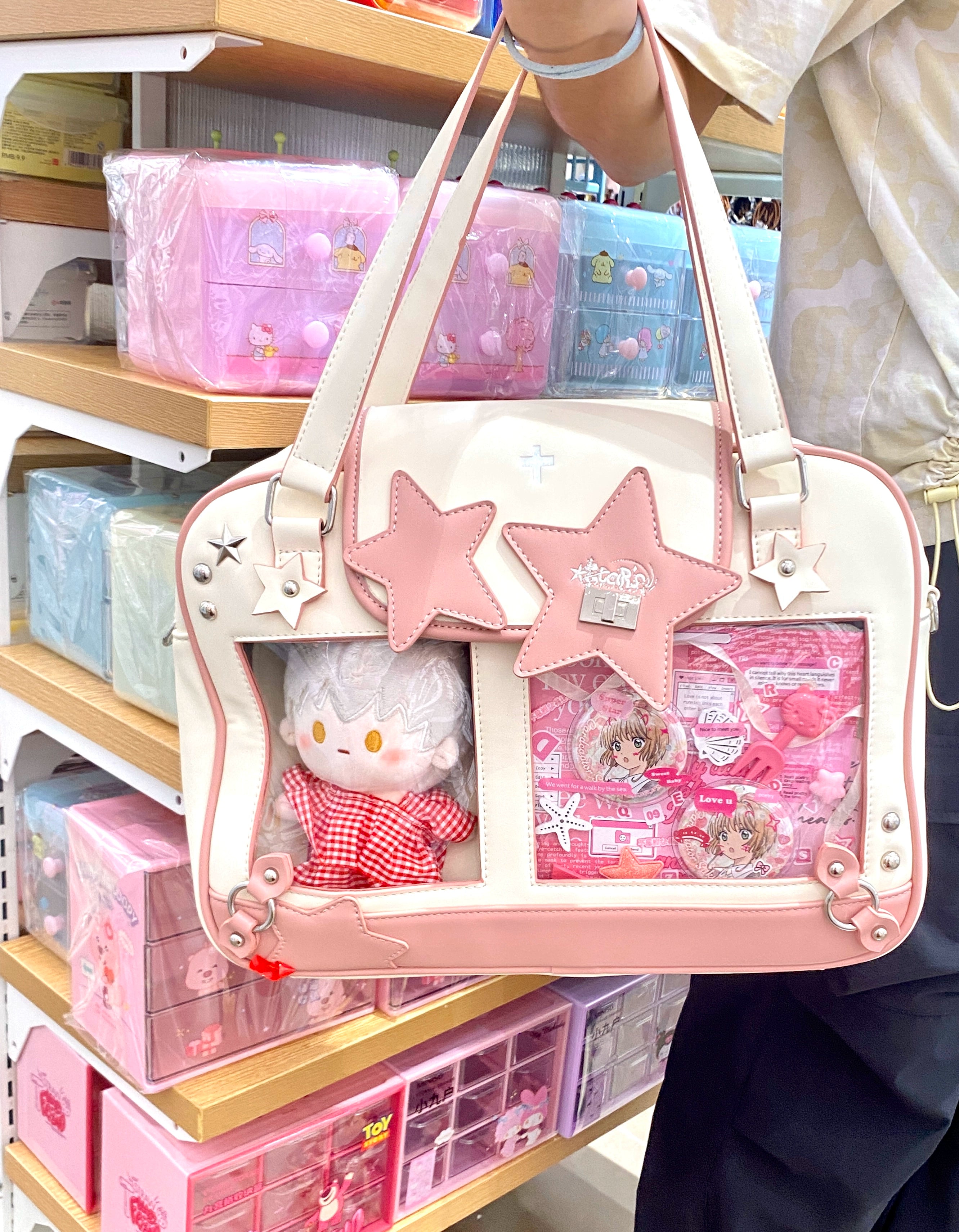 Pink white Jirai Kei star itabag side view with wearer arm convenience store shelf anime bag