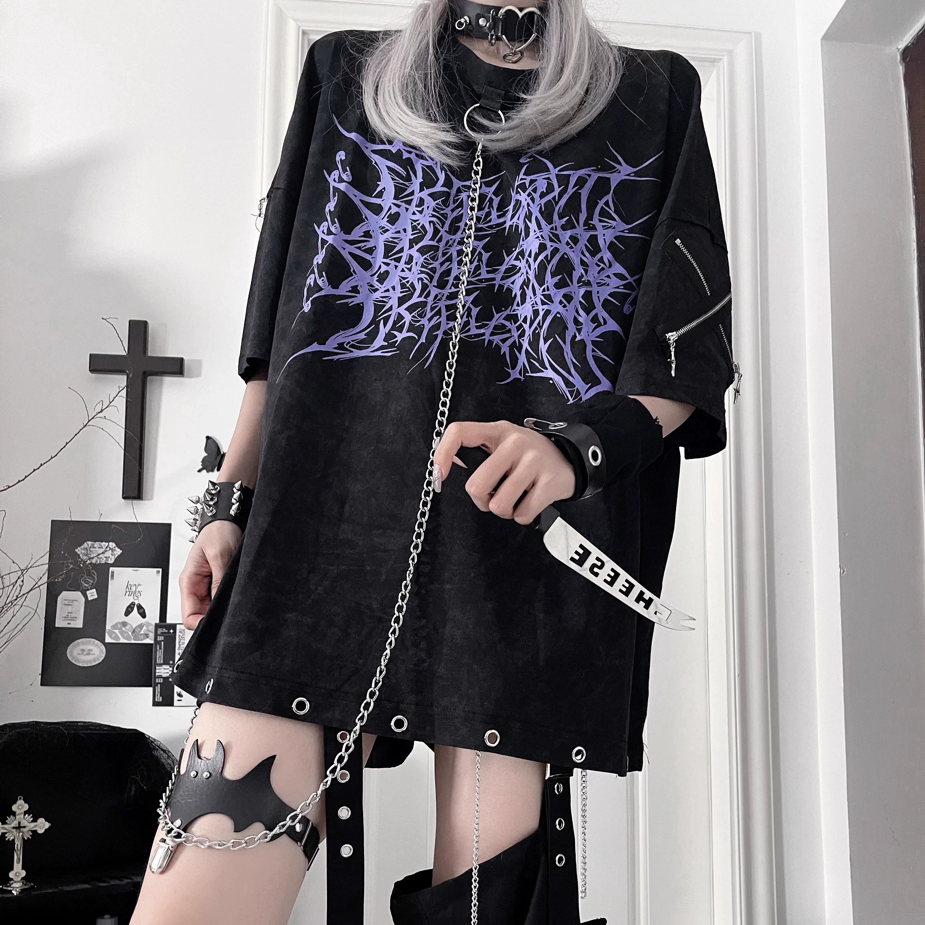 Half-body close-up of Jirai Kei subculture t-shirt with purple thorn print, detachable chain and spiked wrist accessories detail