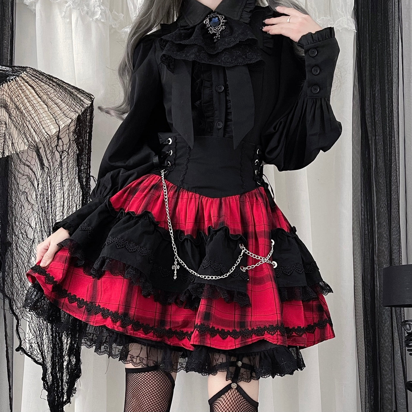 Red and black Jirai Kei Gothic Lolita ensemble side profile with ruffled plaid skirt and puff sleeves