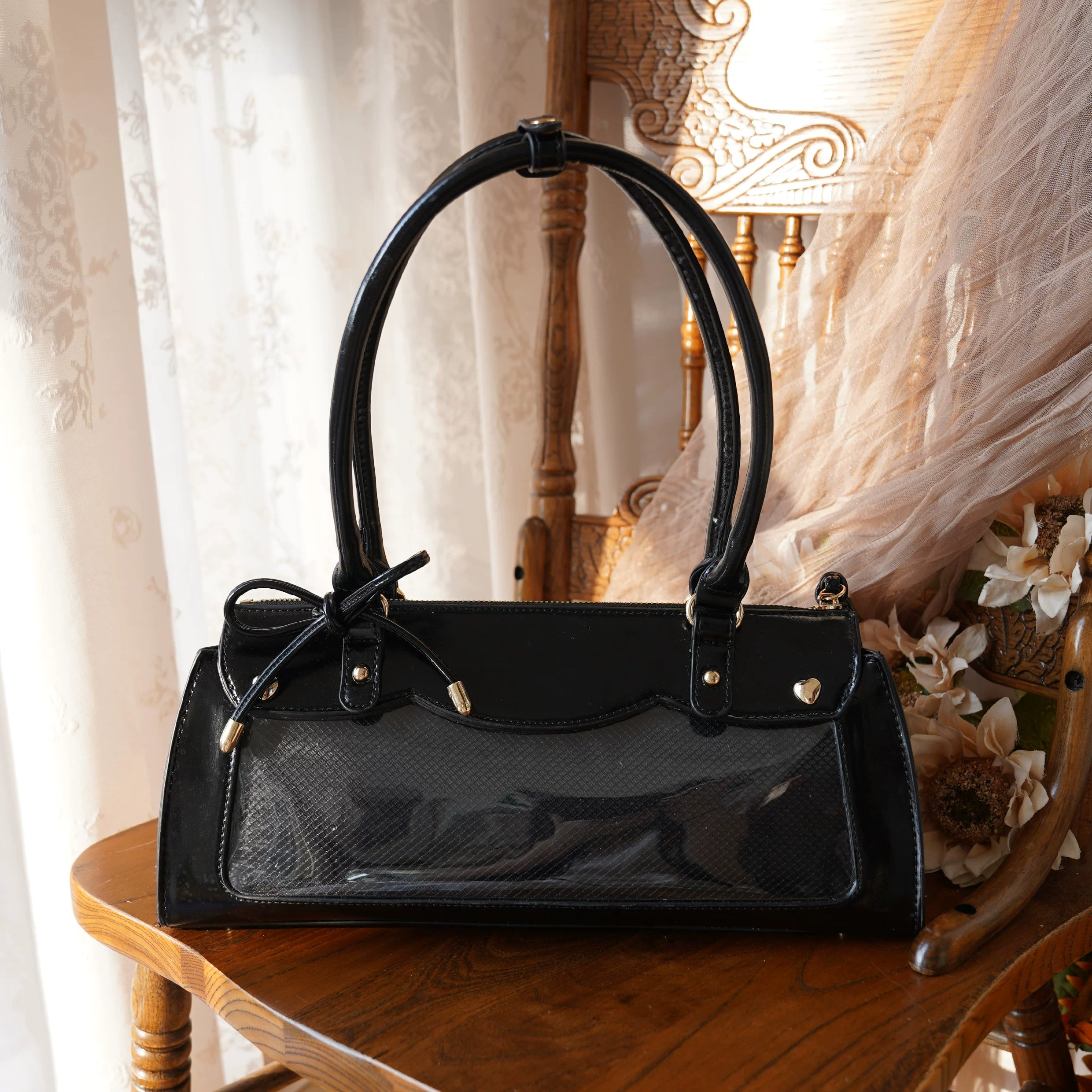 Black baguette itabag with anime character badge showcase display and detachable crossbody carrying strap