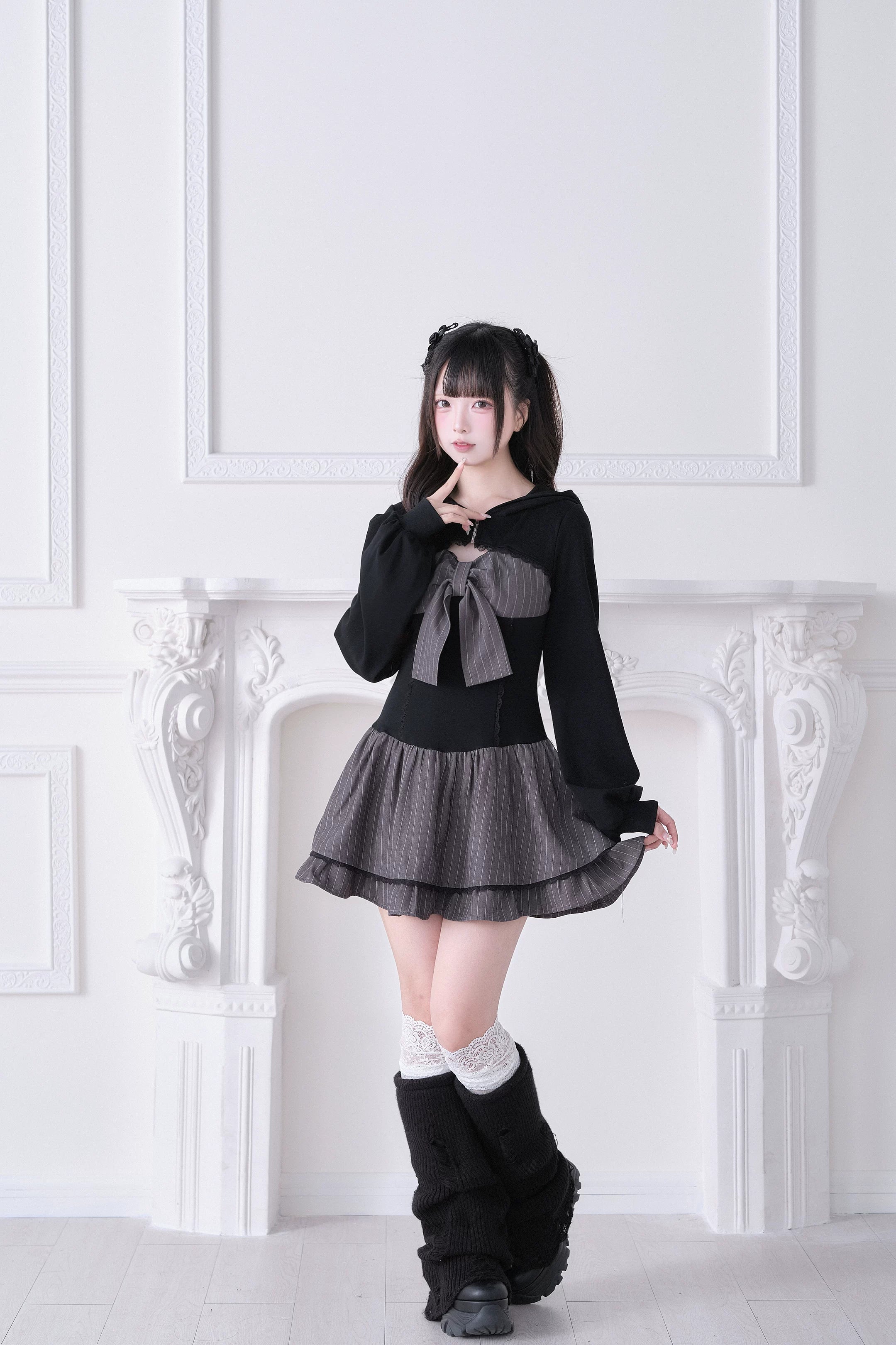 Jirai Kei hoodie one-piece dress three-quarter left view with grey bow accent, grey ruffled hem and tall black boots
